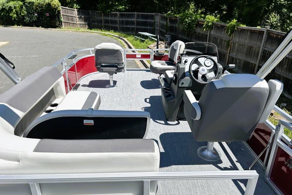 2026 Sun Tracker Bass Buggy 16 XL Select pontoon boat interior with seating and steering console.