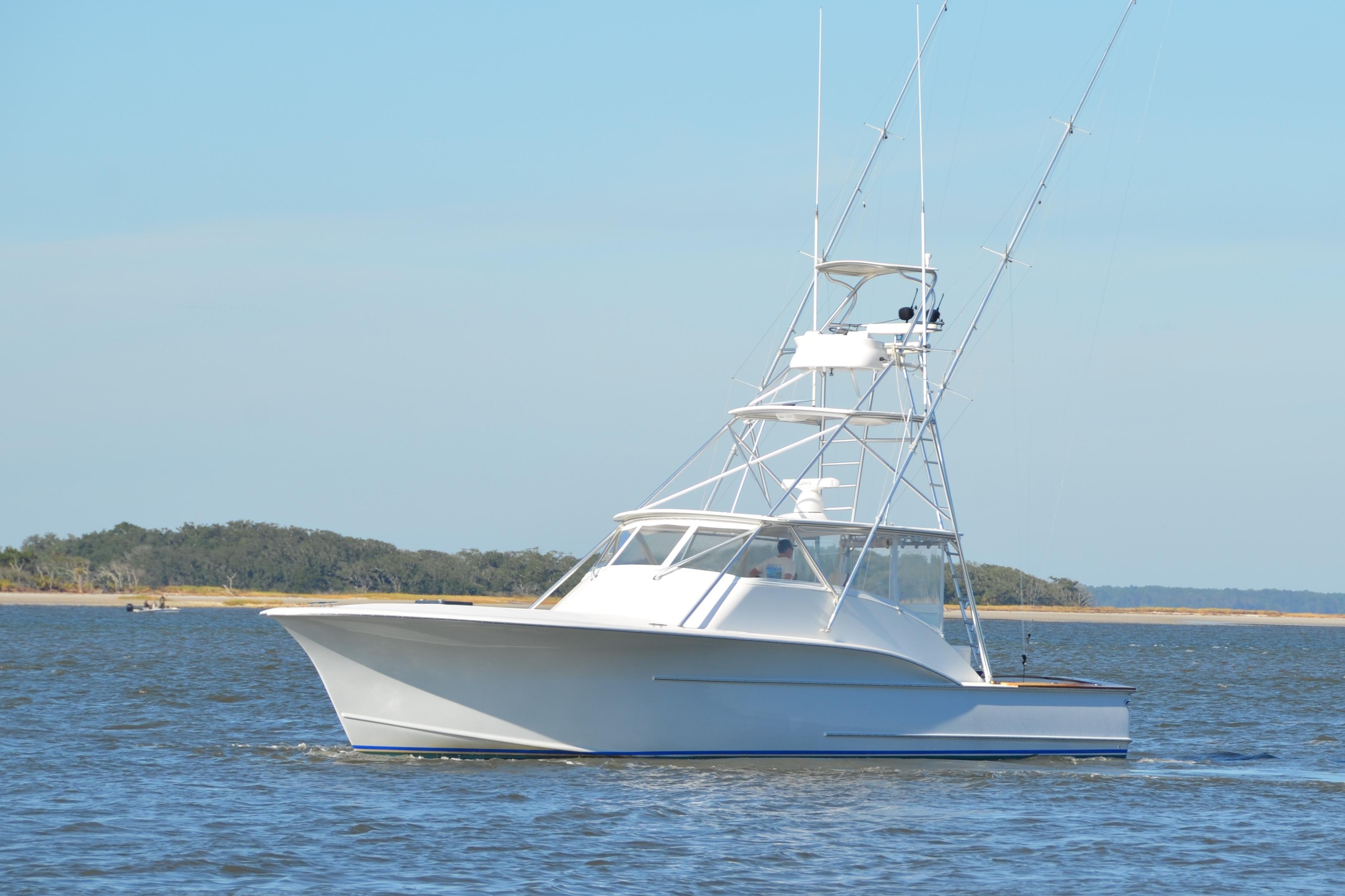 2006 Custom Carolina Heritage Express boat cruising on open water.