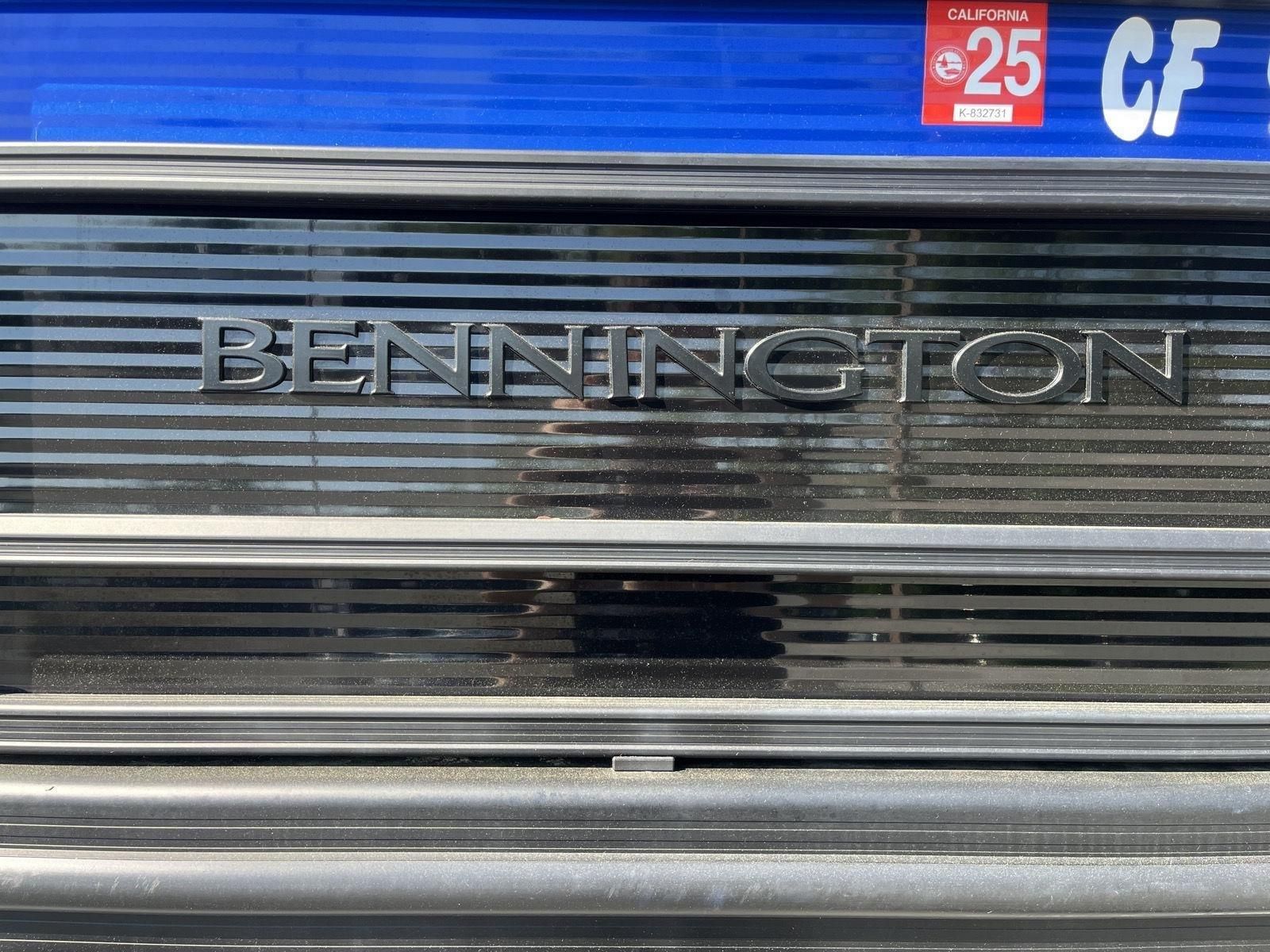 Close-up of the Bennington logo on a boat with a California registration sticker.