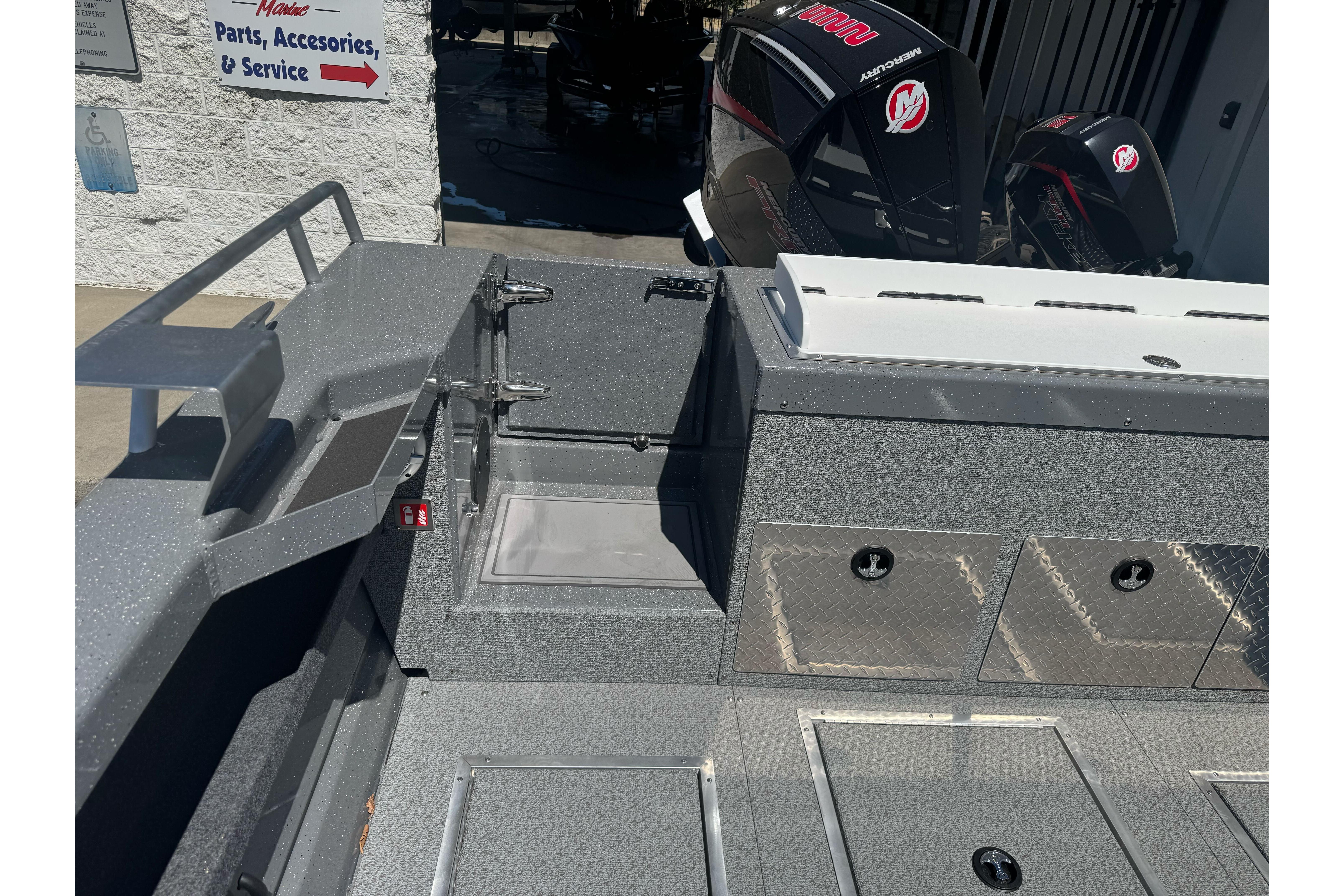 2026 Lund 210 Heavy Gauge boat interior with storage compartments and Mercury outboard motors.