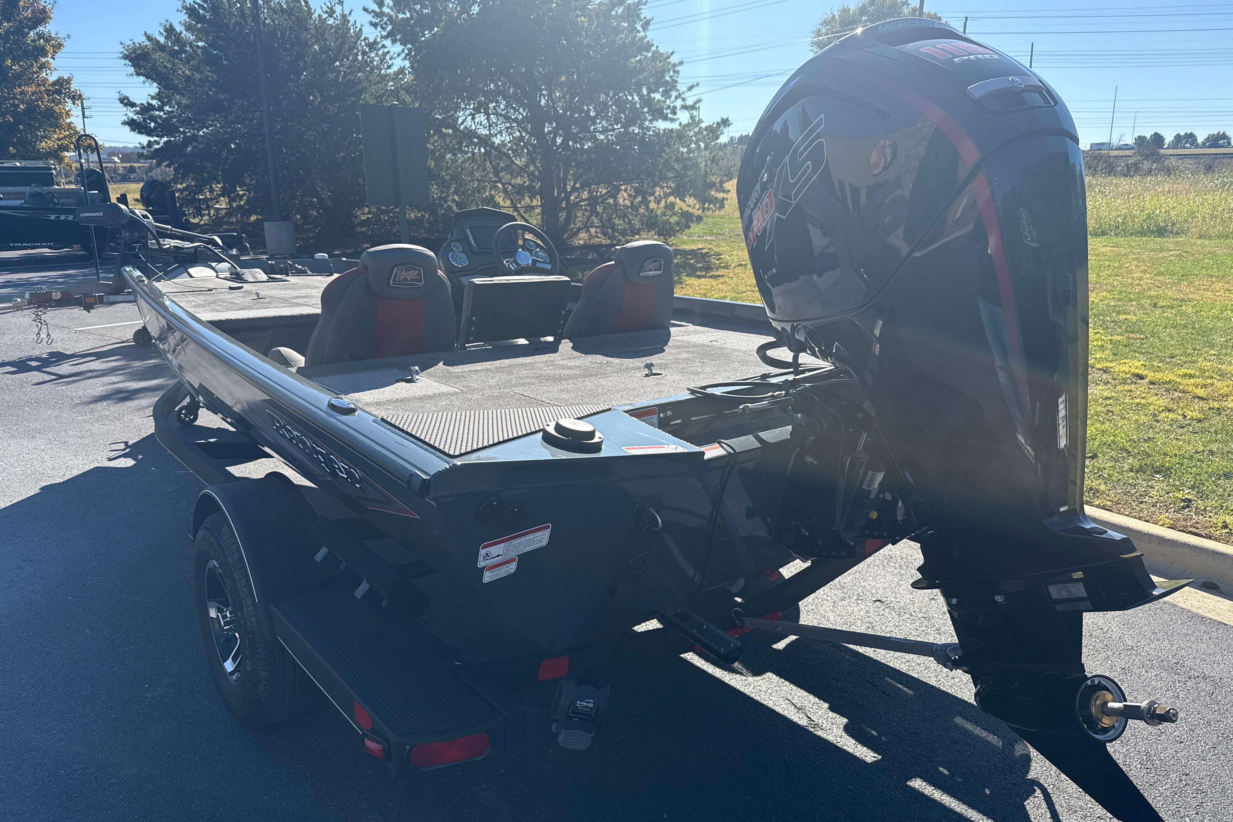 2025 Ranger RT188 boat with powerful outboard motor in a sunny outdoor setting.