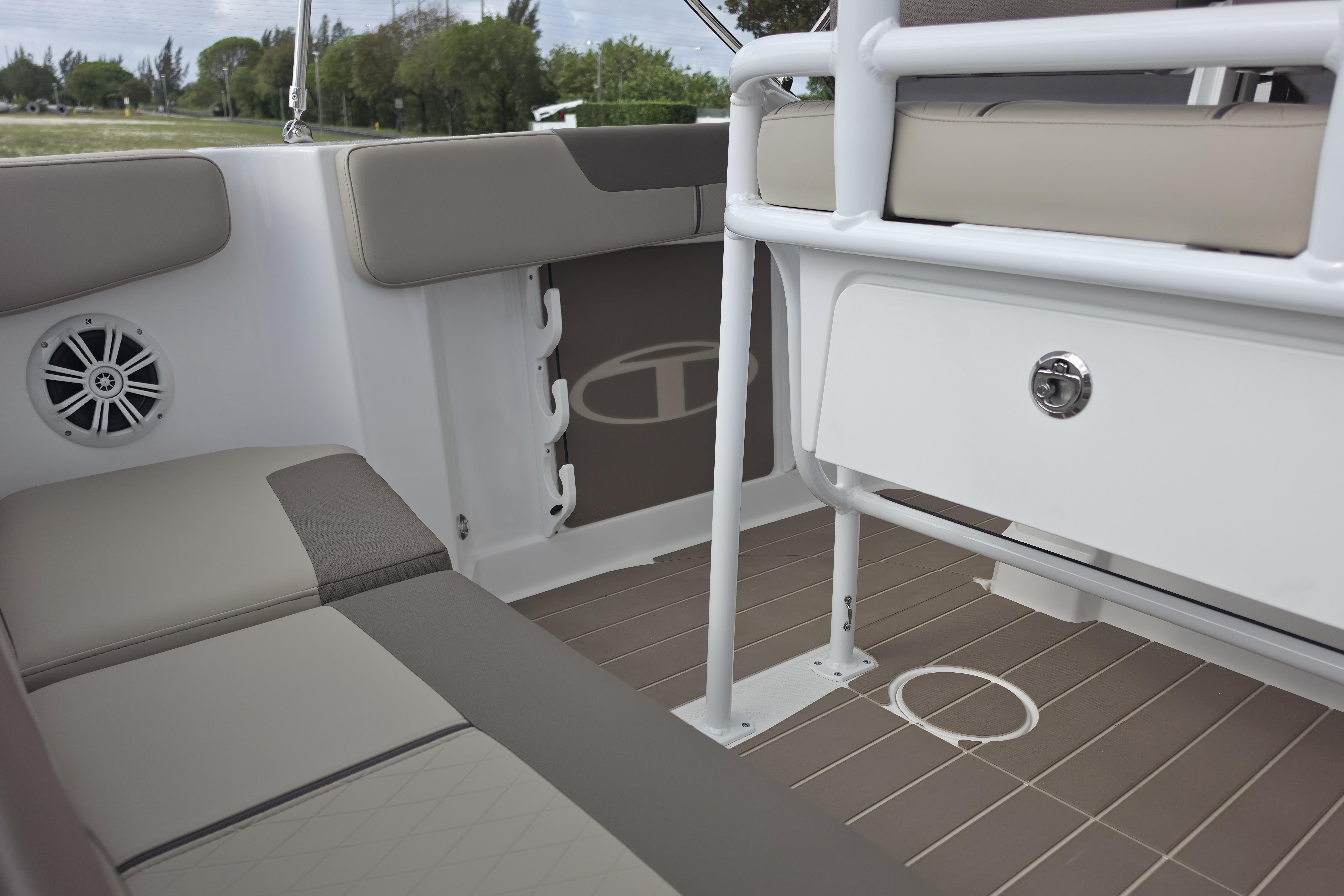 Interior of 2026 Tahoe 2150 CC boat with beige seating and storage compartment.