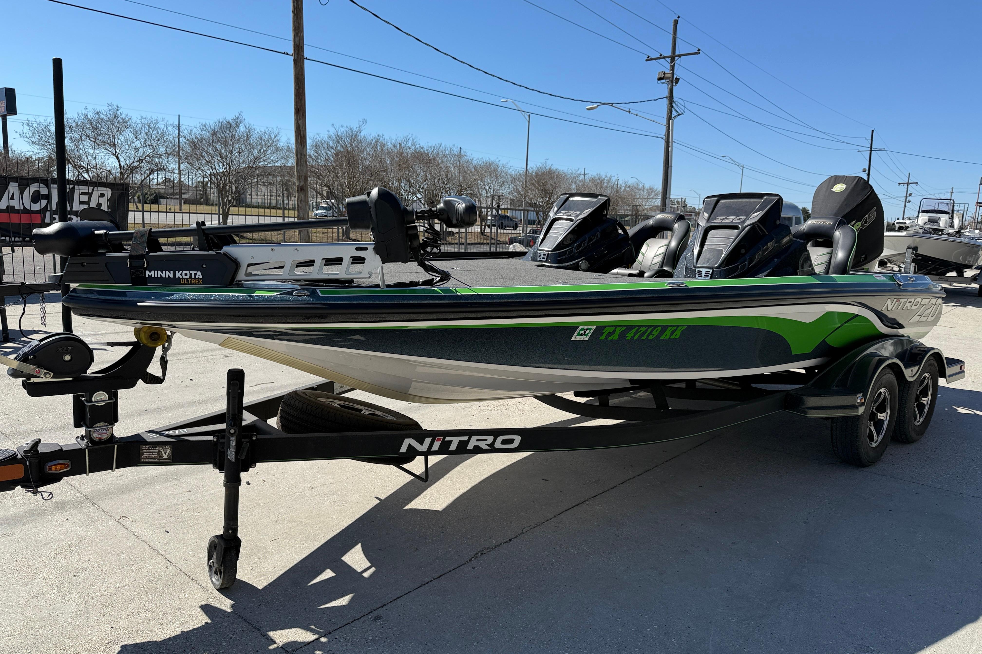 2020 Nitro Z20 fishing boat with Minn Kota motor on trailer, parked outdoors.