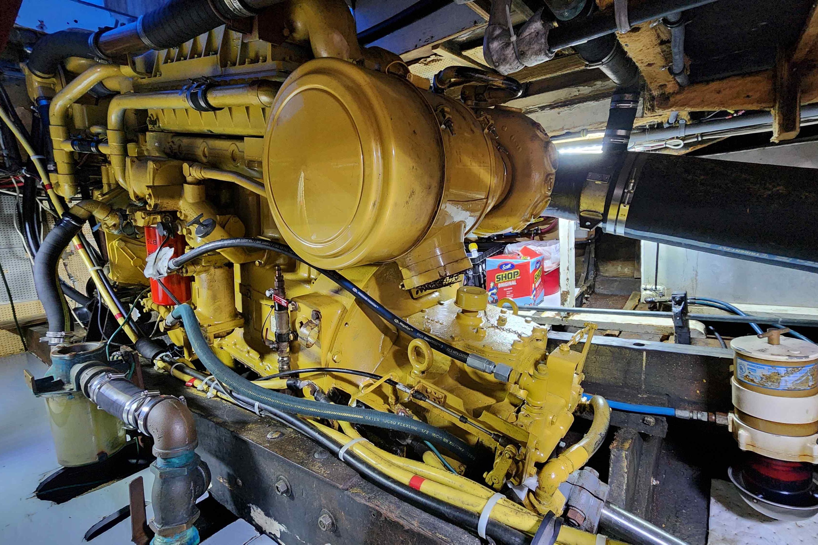 Engine room of a 1964 Grandy Tour Boat, showcasing a detailed view of the machinery.