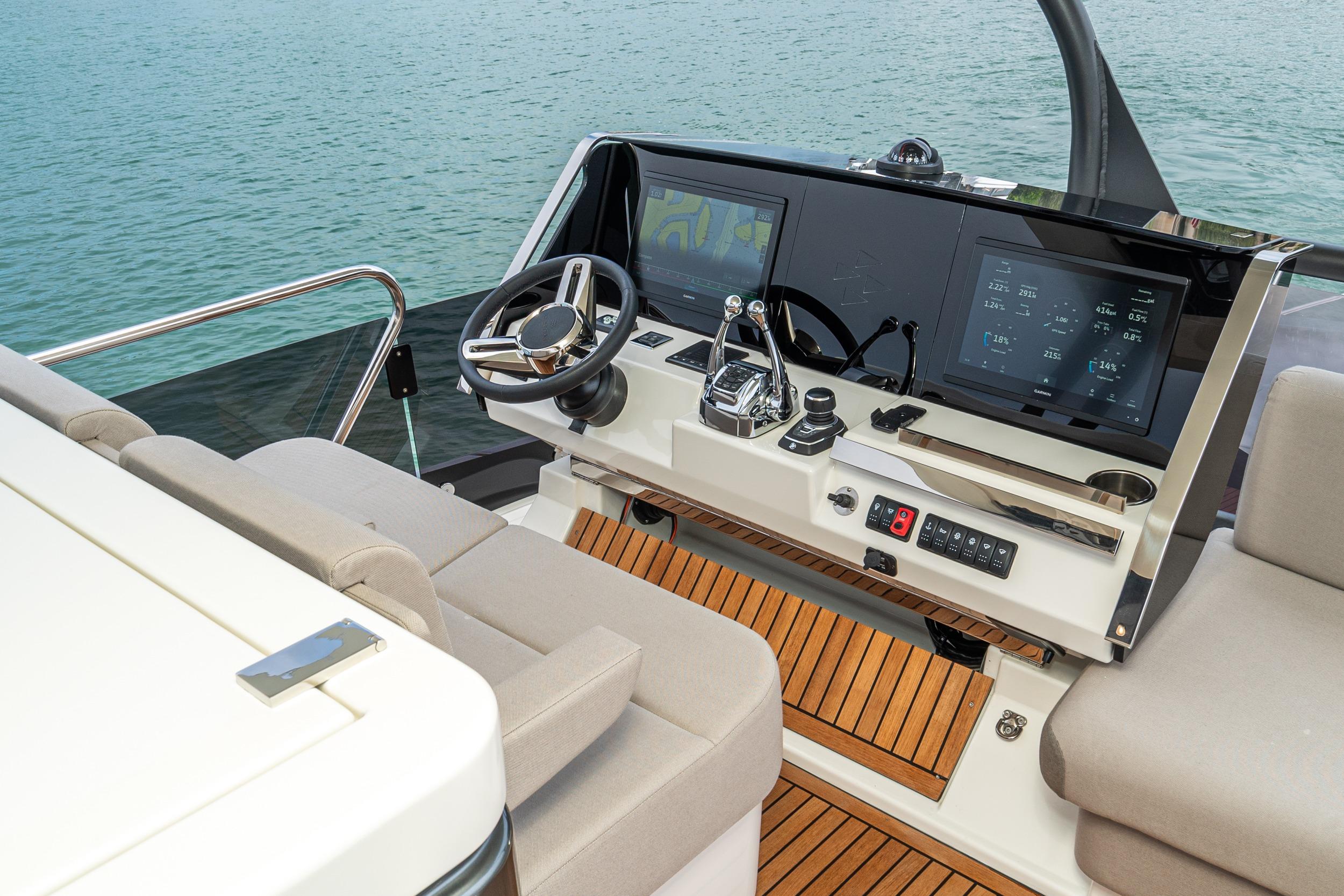 Luxurious 2024 Prestige X60 yacht helm with modern controls and dual screens.