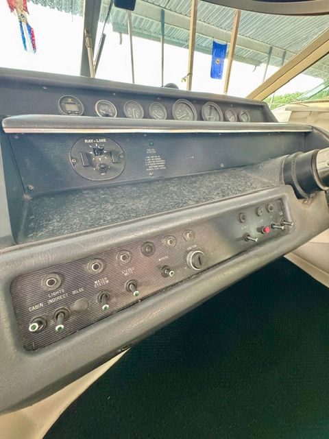 Dashboard of a 1992 Sea Ray 290 Sundancer with various switches and gauges.