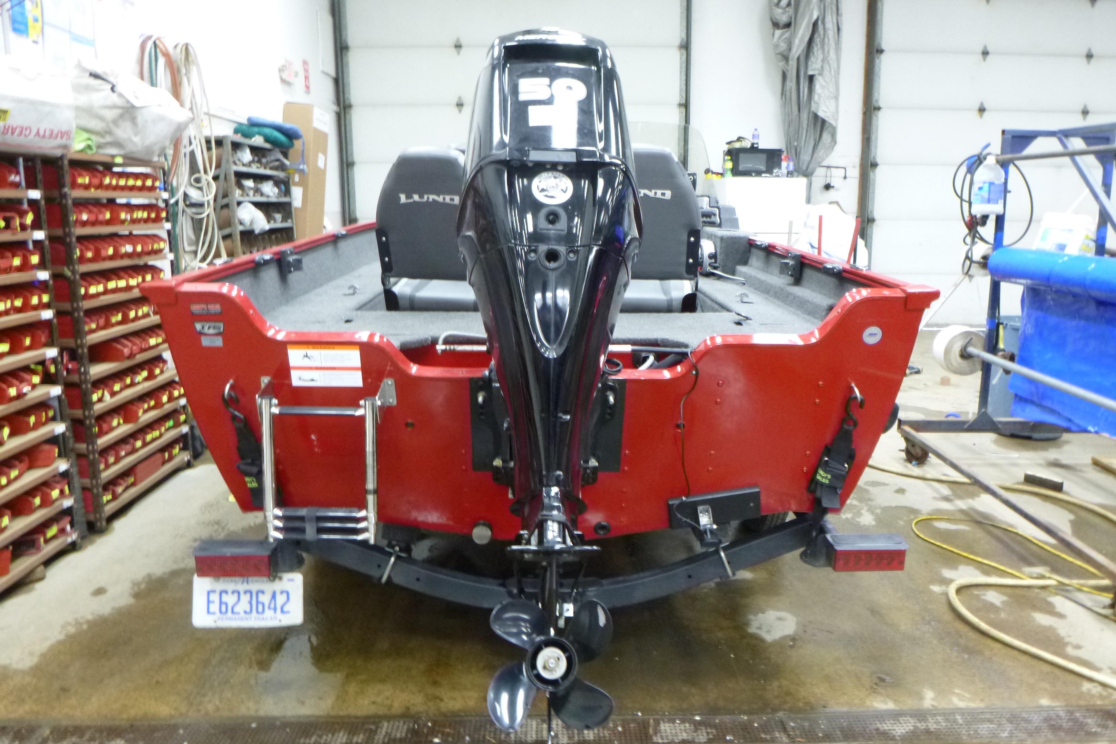 2022 Lund 1650 Angler Sport boat in garage, rear view with motor.