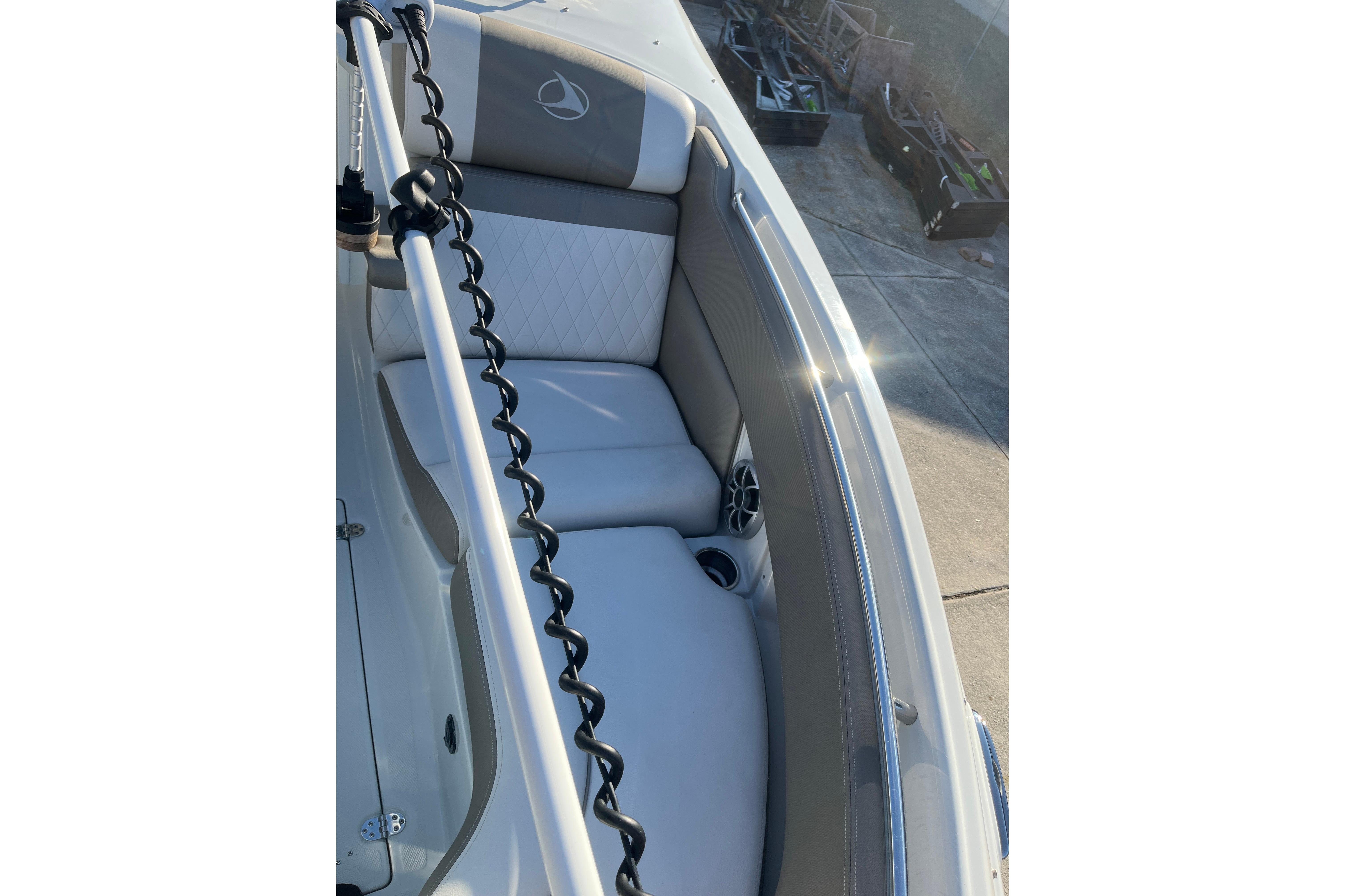 2022 Finseeker 280 DC boat interior with cushioned seating and cup holders.