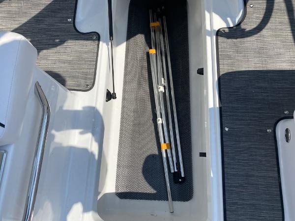 2021 Scarab 255 Open ID boat interior storage compartment with metal rods.