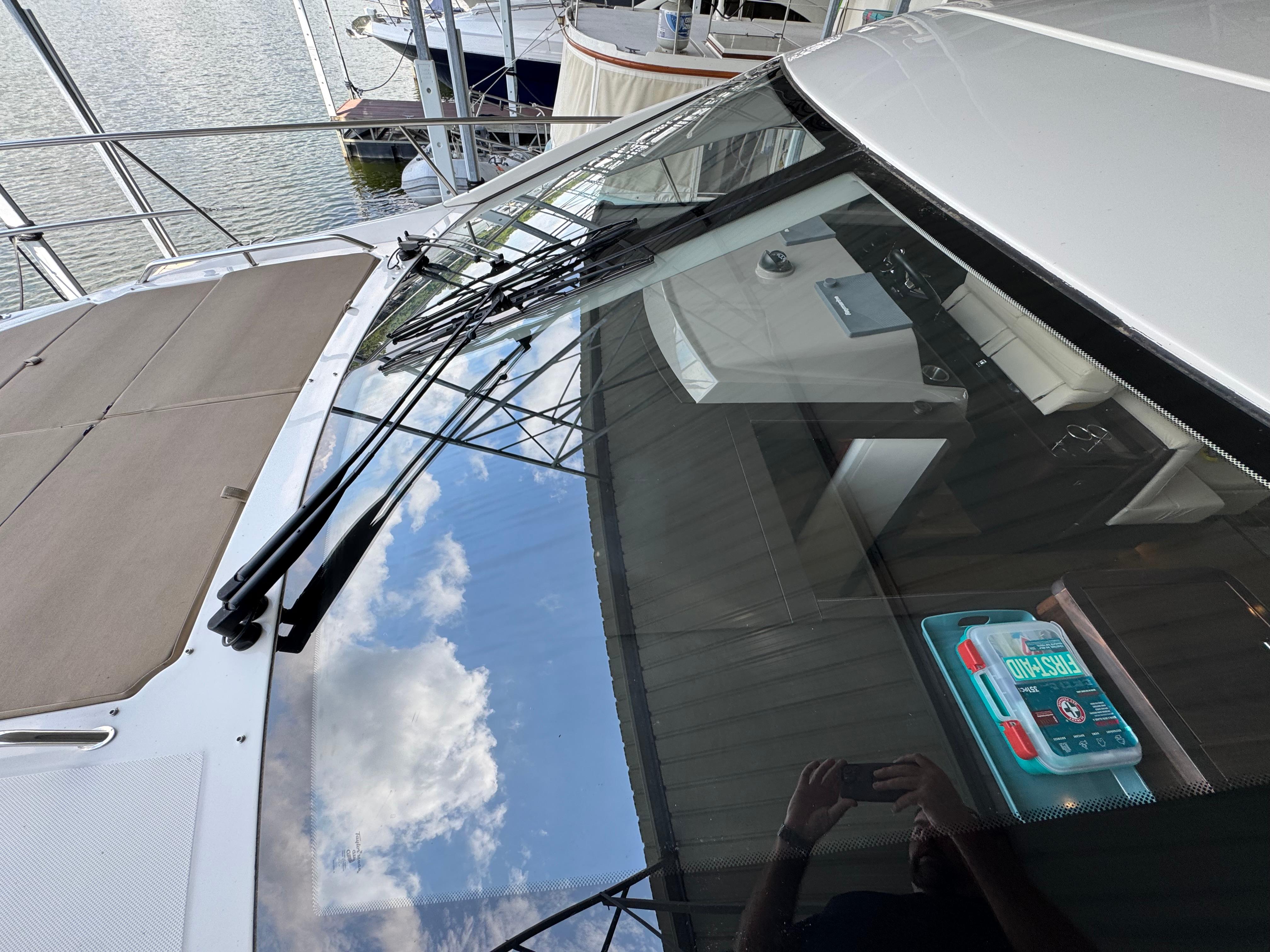 2017 Sea Ray Sundancer 400 yacht with reflective windshield and visible interior details.