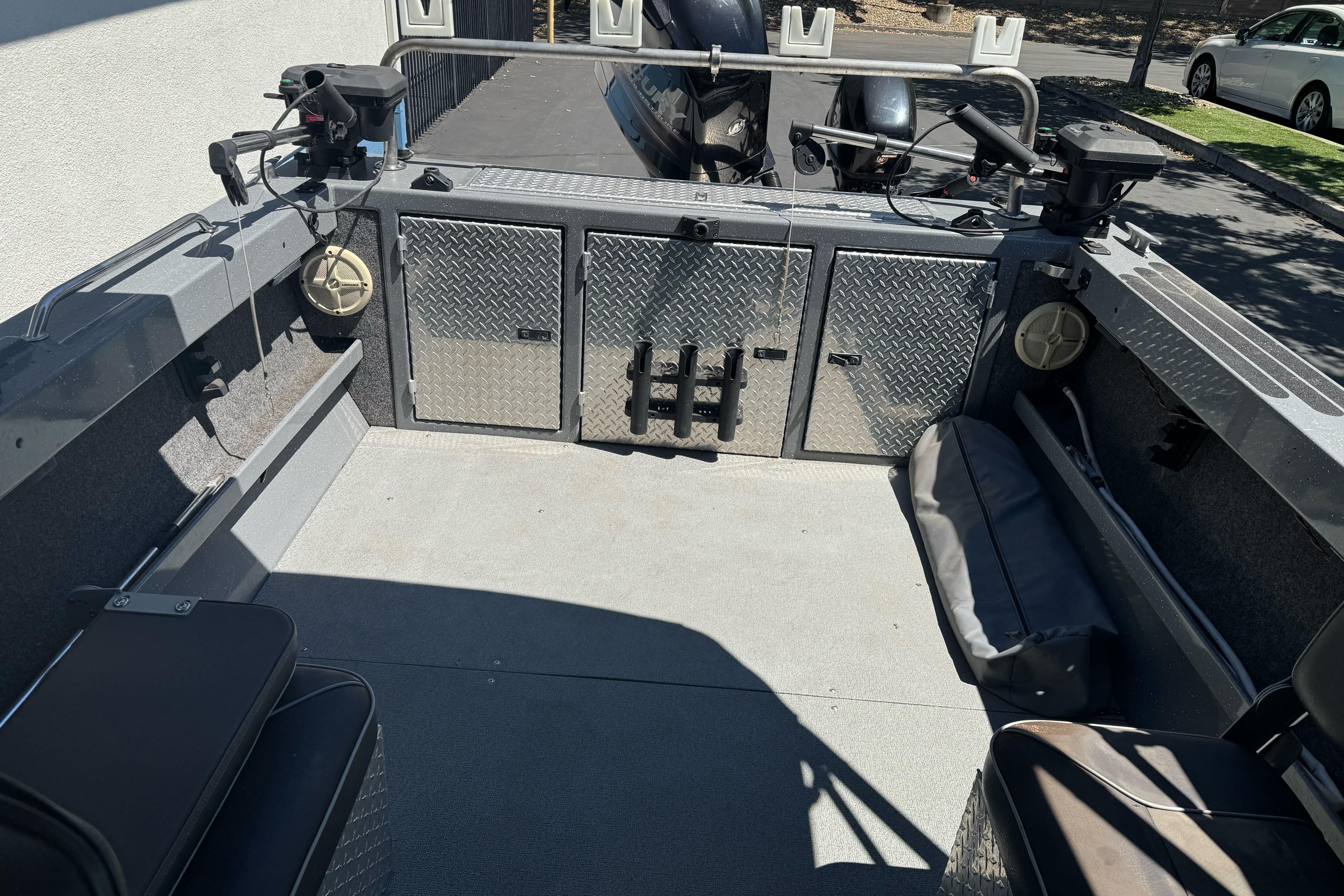 Interior of a 2014 River Hawk 19 GB boat with storage compartments and seating.