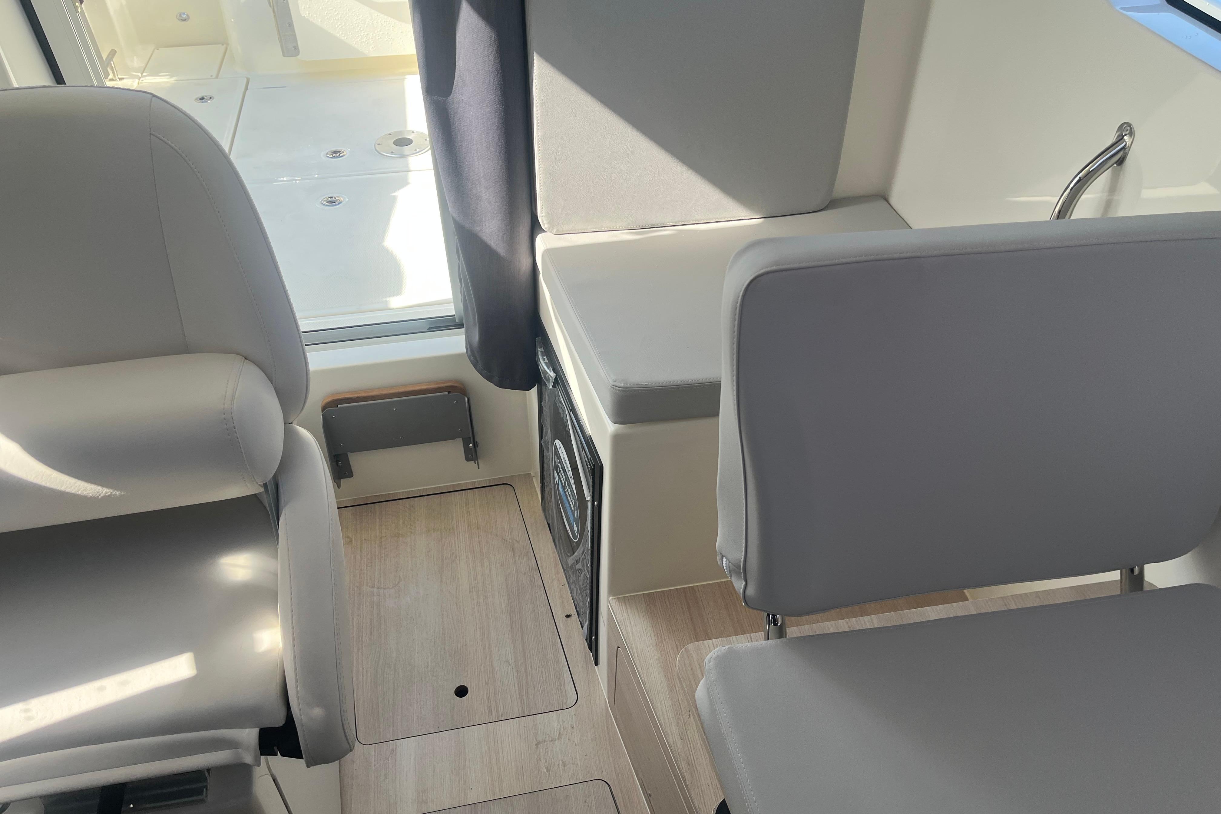 Interior of 2025 Bayliner Trophy T25 Pilothouse with modern seating and sleek design.