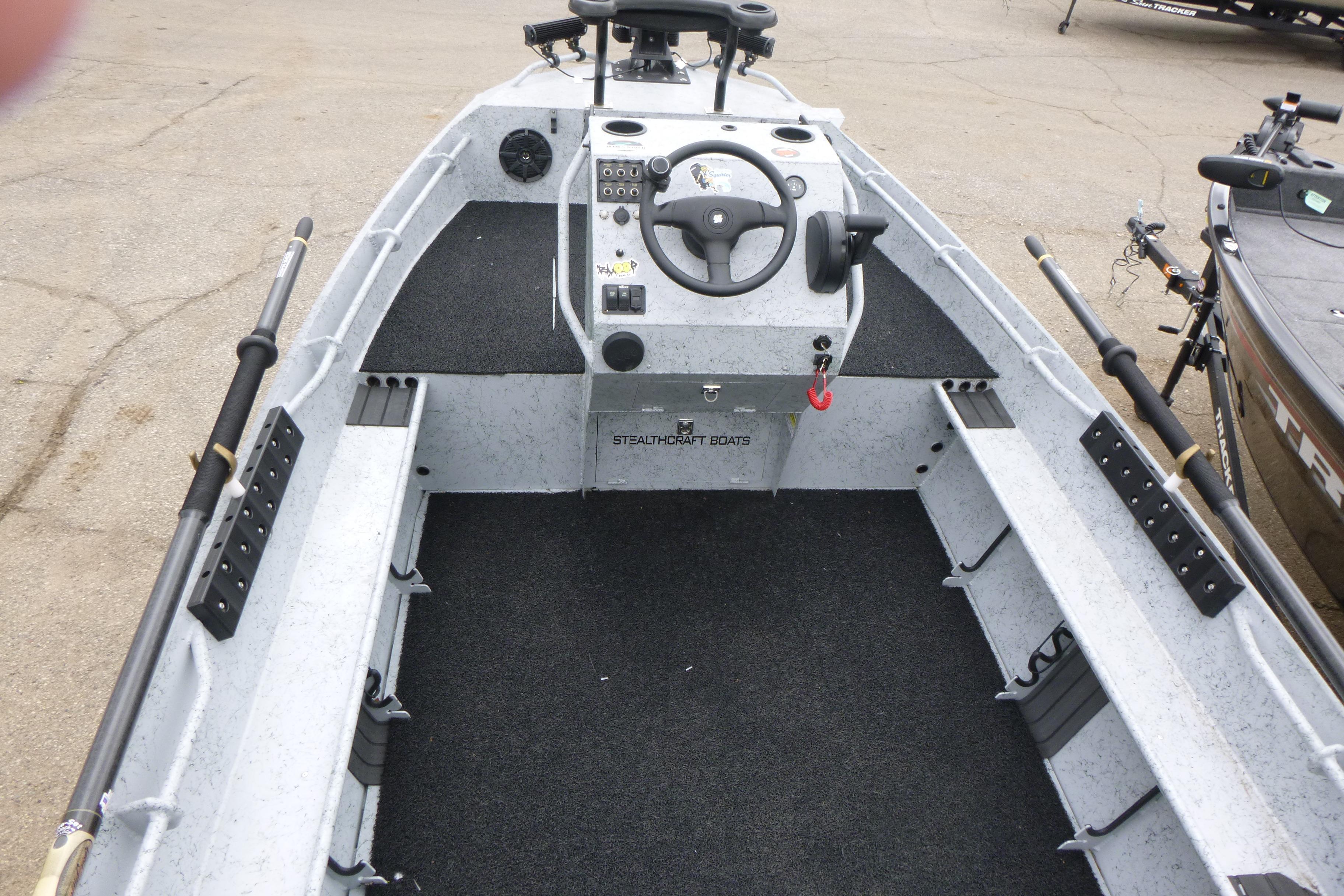 2025 StealthCraft 16 StealthWeld boat interior with steering console and rod holders.