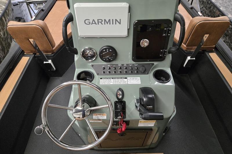Boat dashboard with Garmin navigation, steering wheel, and controls on Avid 207 Recon, 2026 model.