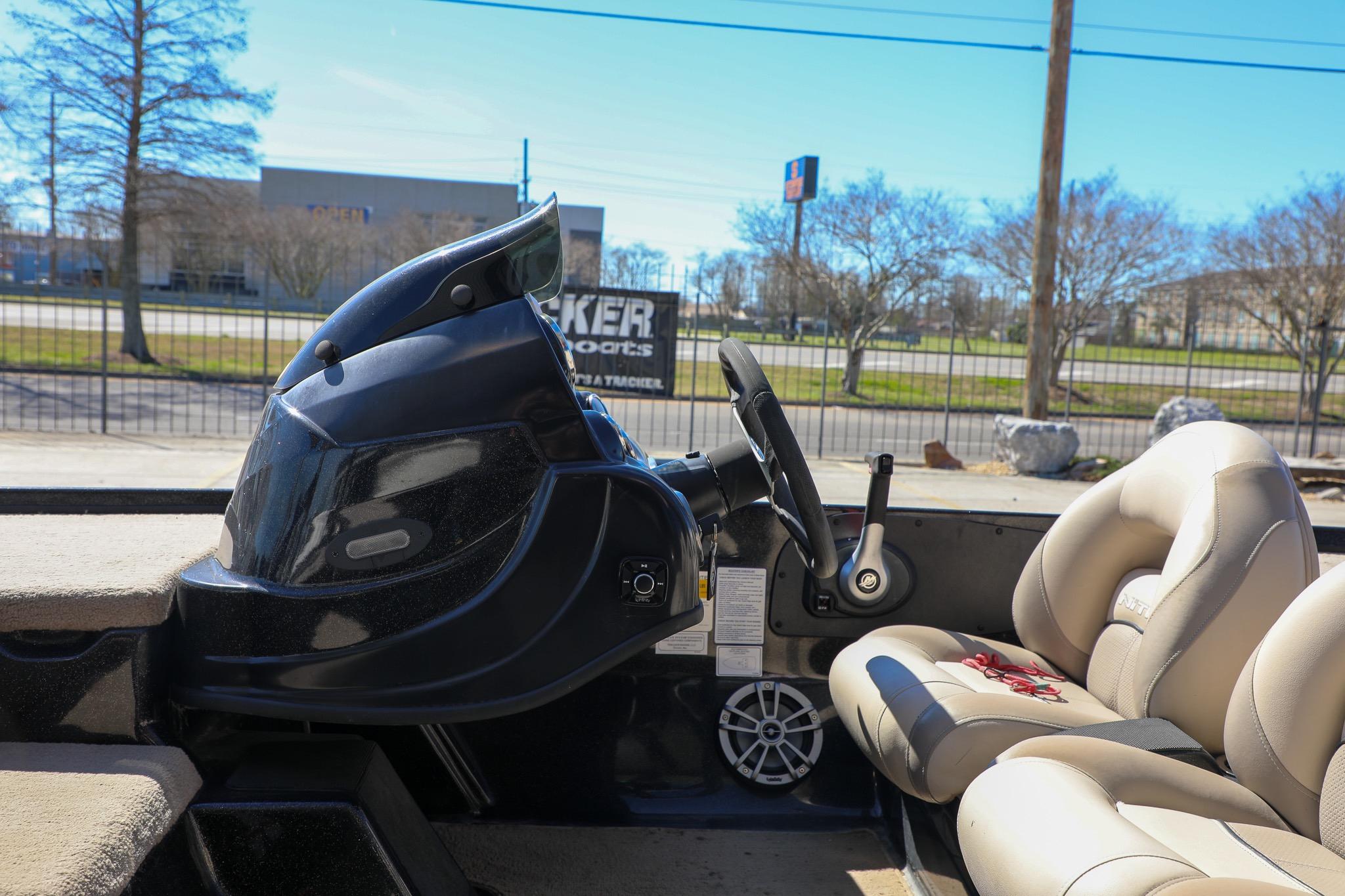 2013 Nitro Z-7 boat interior with steering wheel and beige seats.