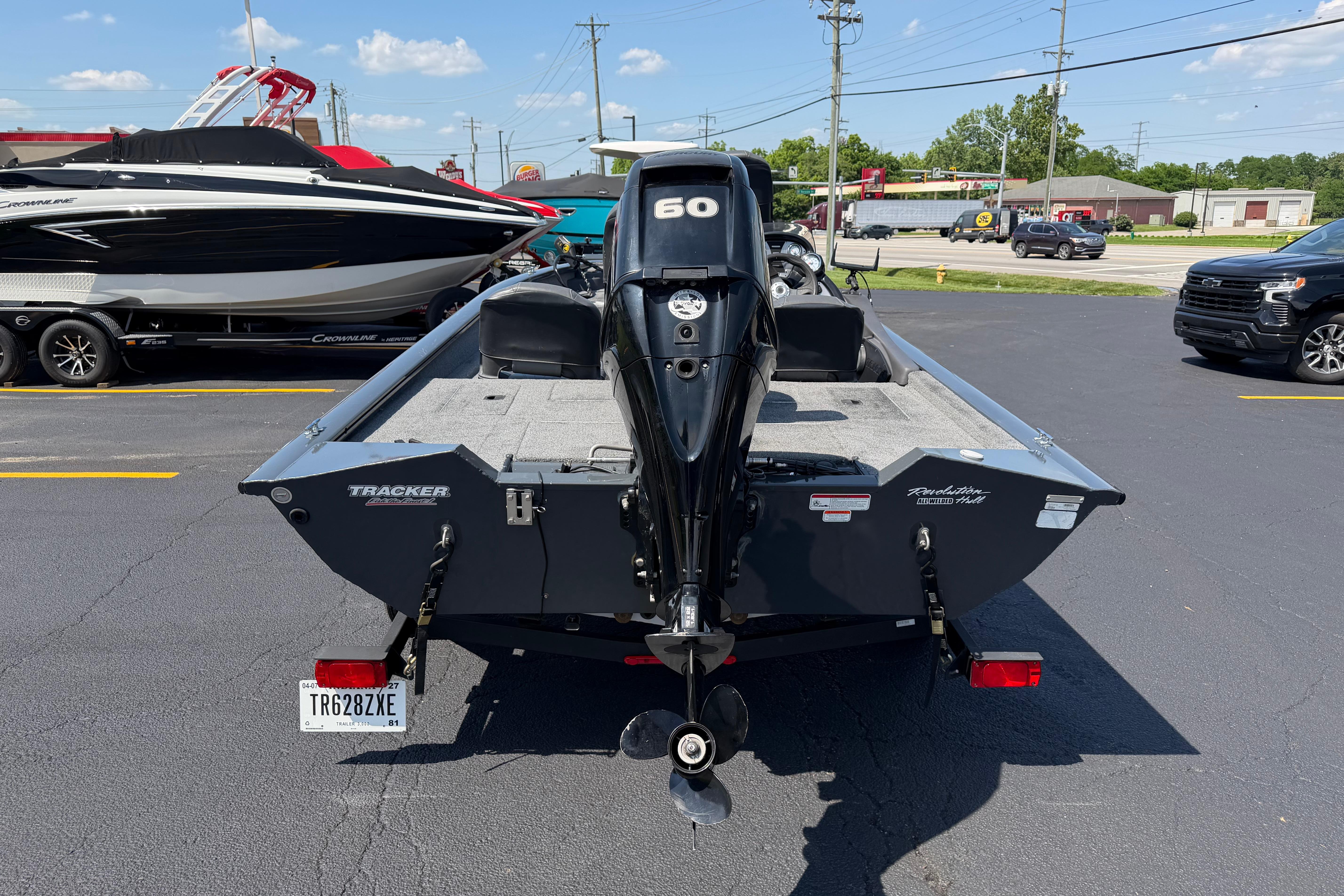 2019 Tracker Pro Team 175 TF boat with outboard motor in parking lot.
