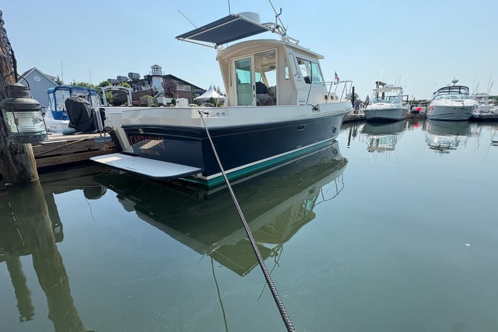 2003 Albin 28 Tournament Express boat docked in a marina on a sunny day.