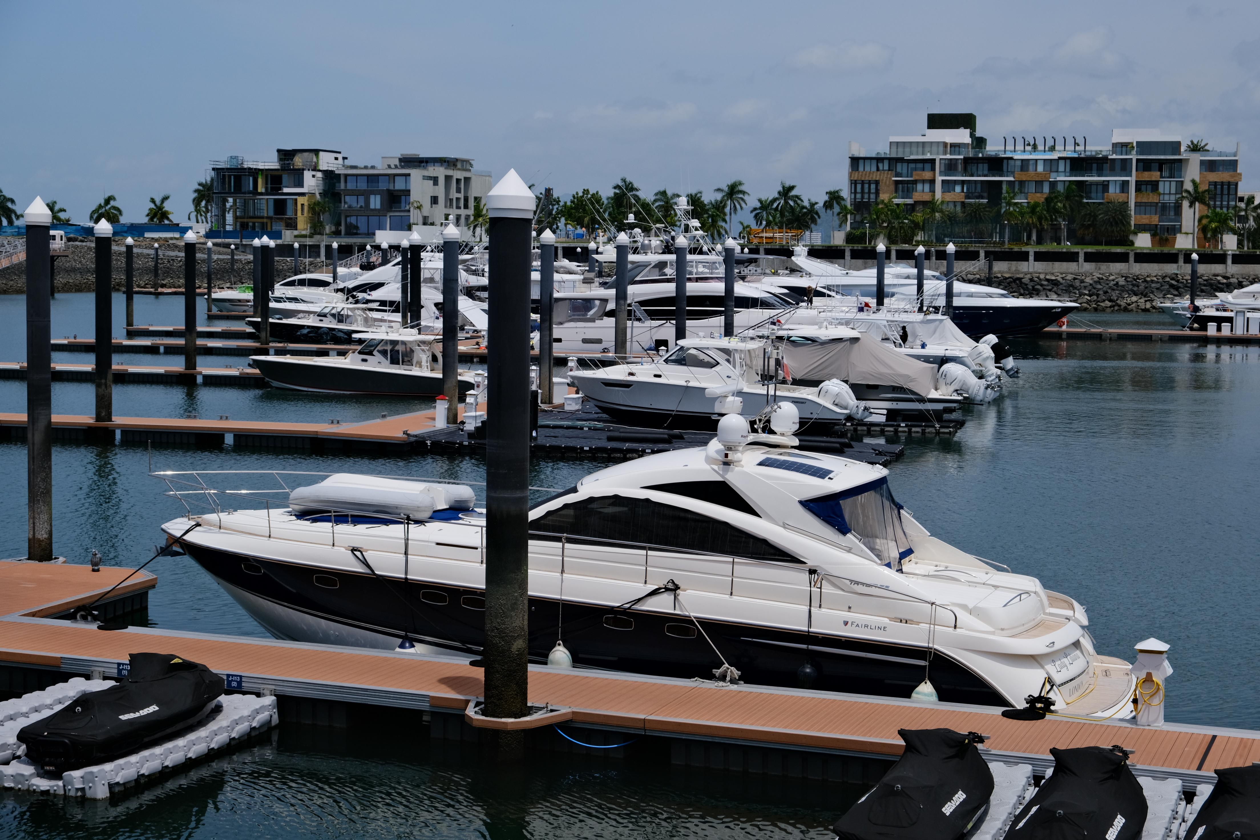 2007 Fairline Targa 52 GT yacht docked in a marina with modern buildings in the background.