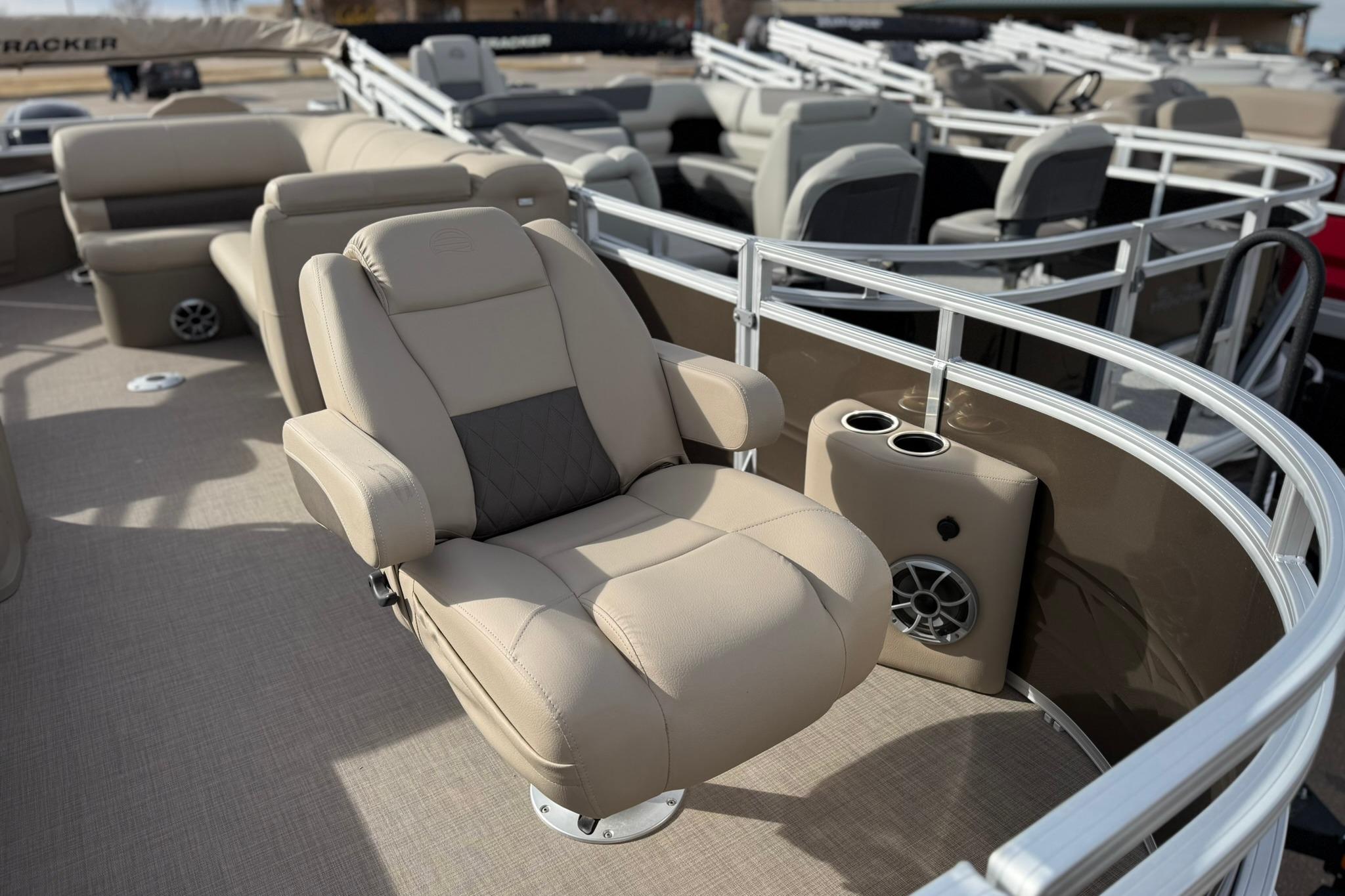 2025 Sun Tracker SportFish 20 DLX pontoon boat with beige seating and cup holders.