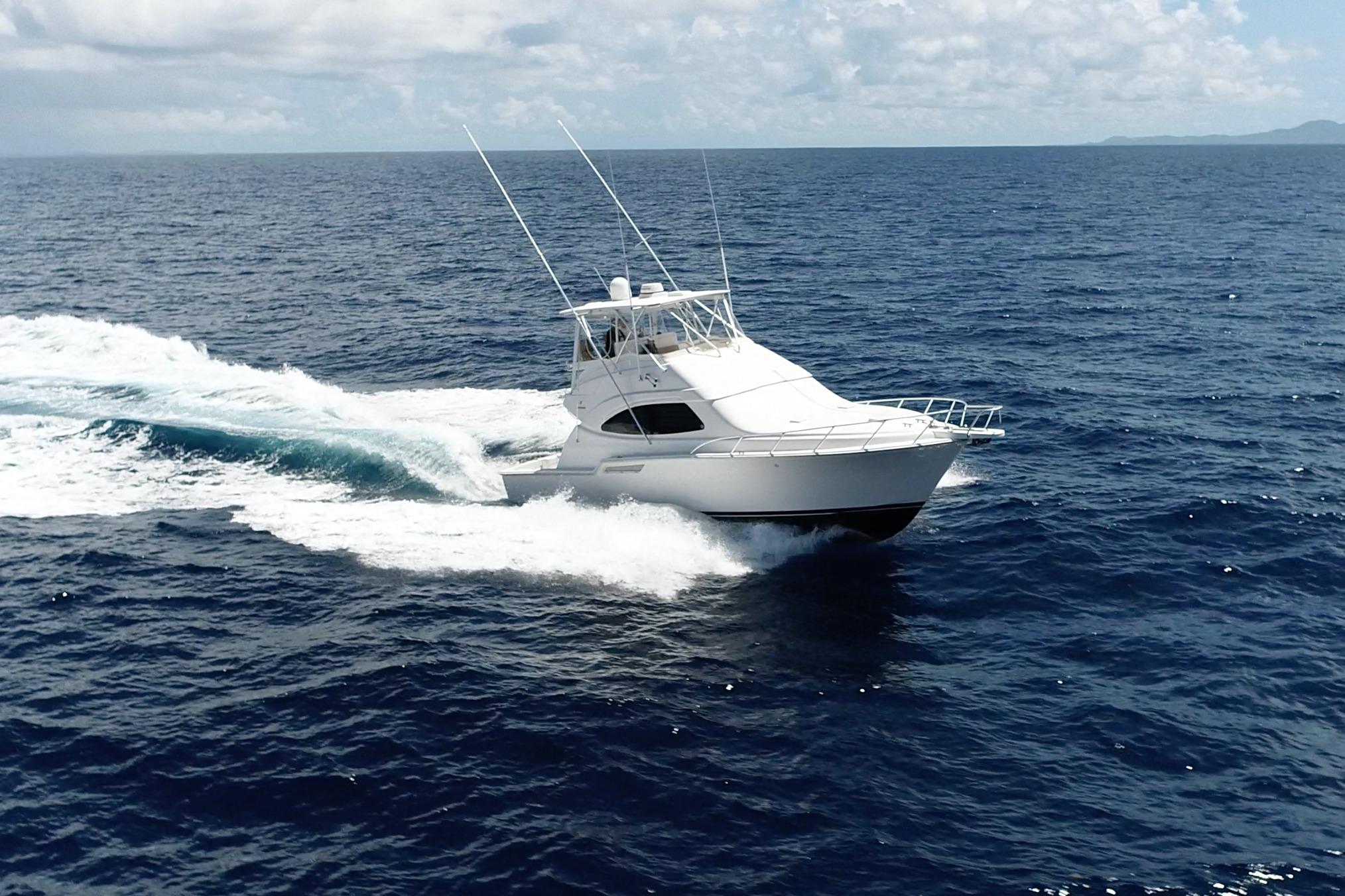 2005 Bertram 450 yacht cruising on open ocean under clear skies.