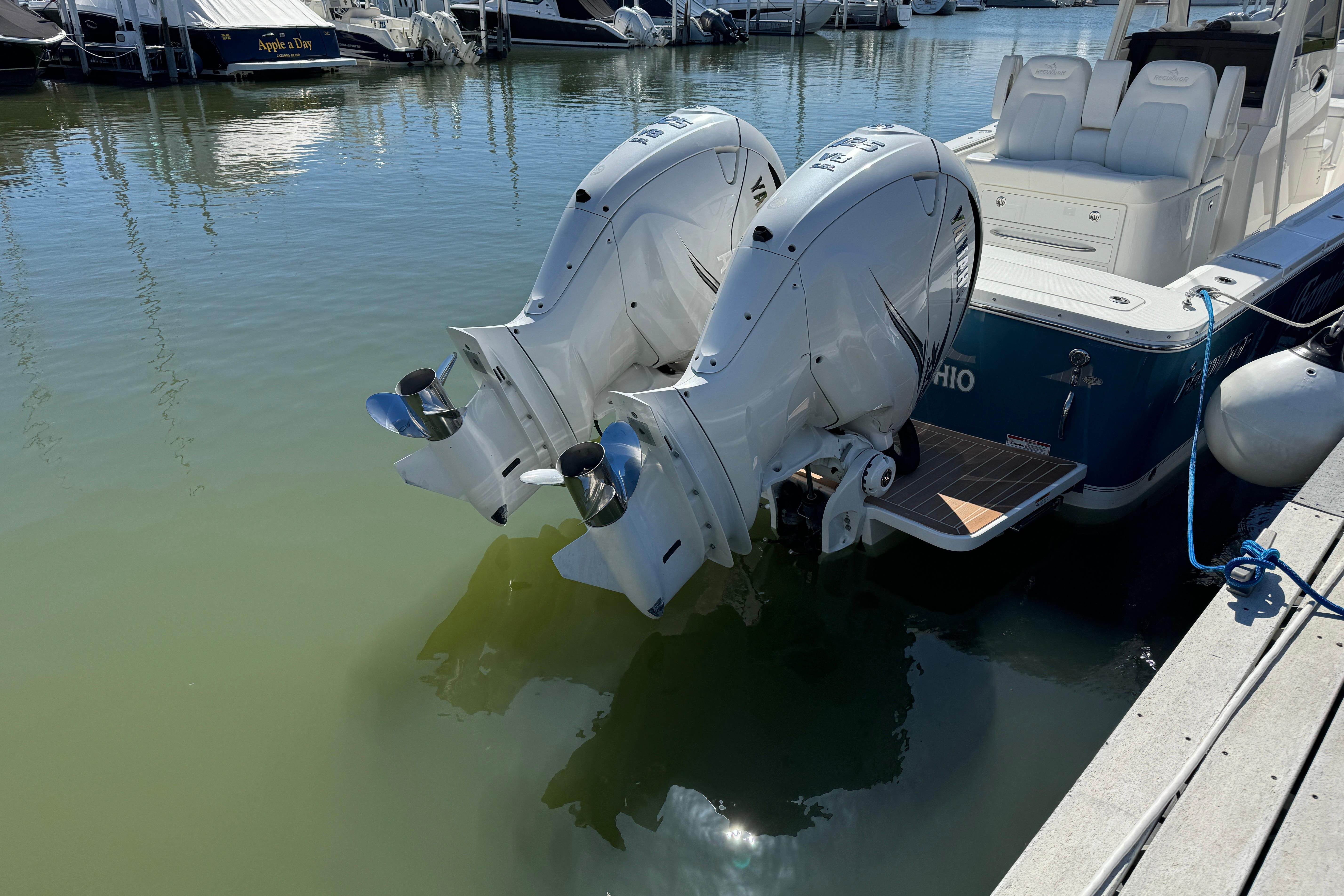 2021 Regulator 31 boat with dual outboard engines docked in marina.