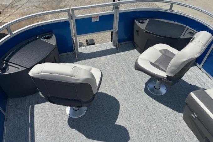 2026 Sun Tracker Fishin' Barge 20 DLX interior with swivel seats and storage compartments.