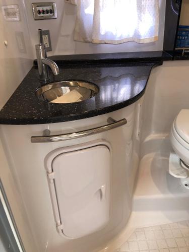 Bathroom with sink and toilet inside a boat.