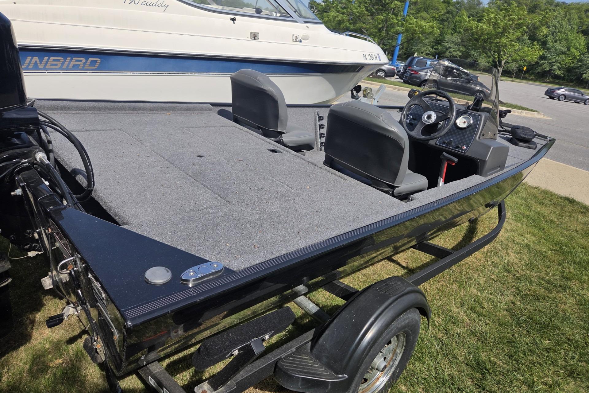 2024 TRACKER MARINE CLASSIC XL boat on trailer, parked outdoors.