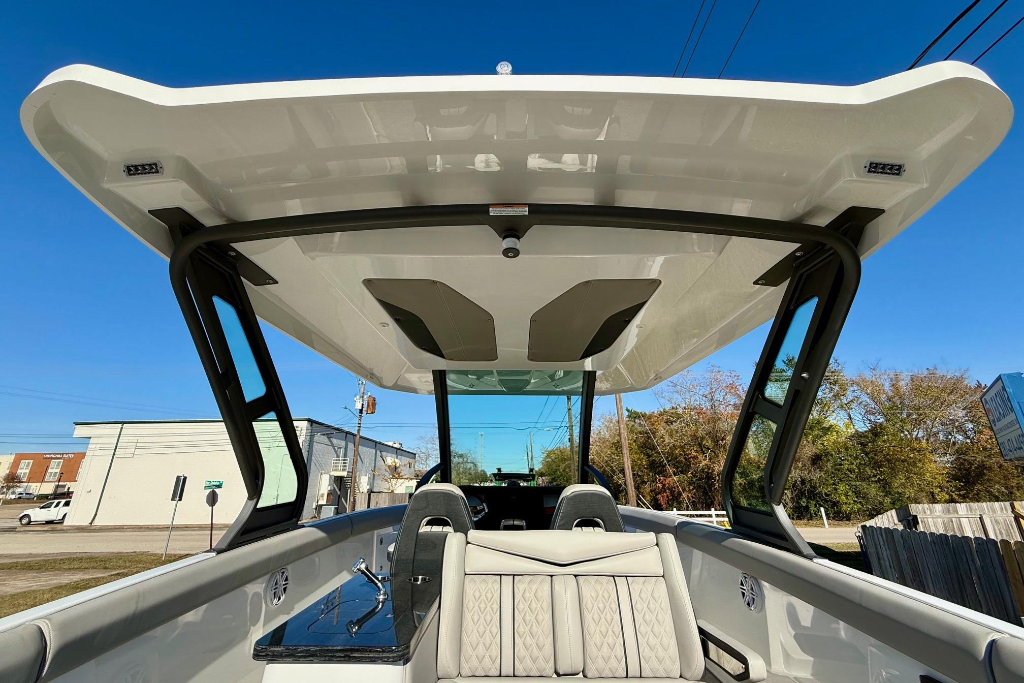 2026 Monterey Elite 30 OB boat with sleek design and sunshade.