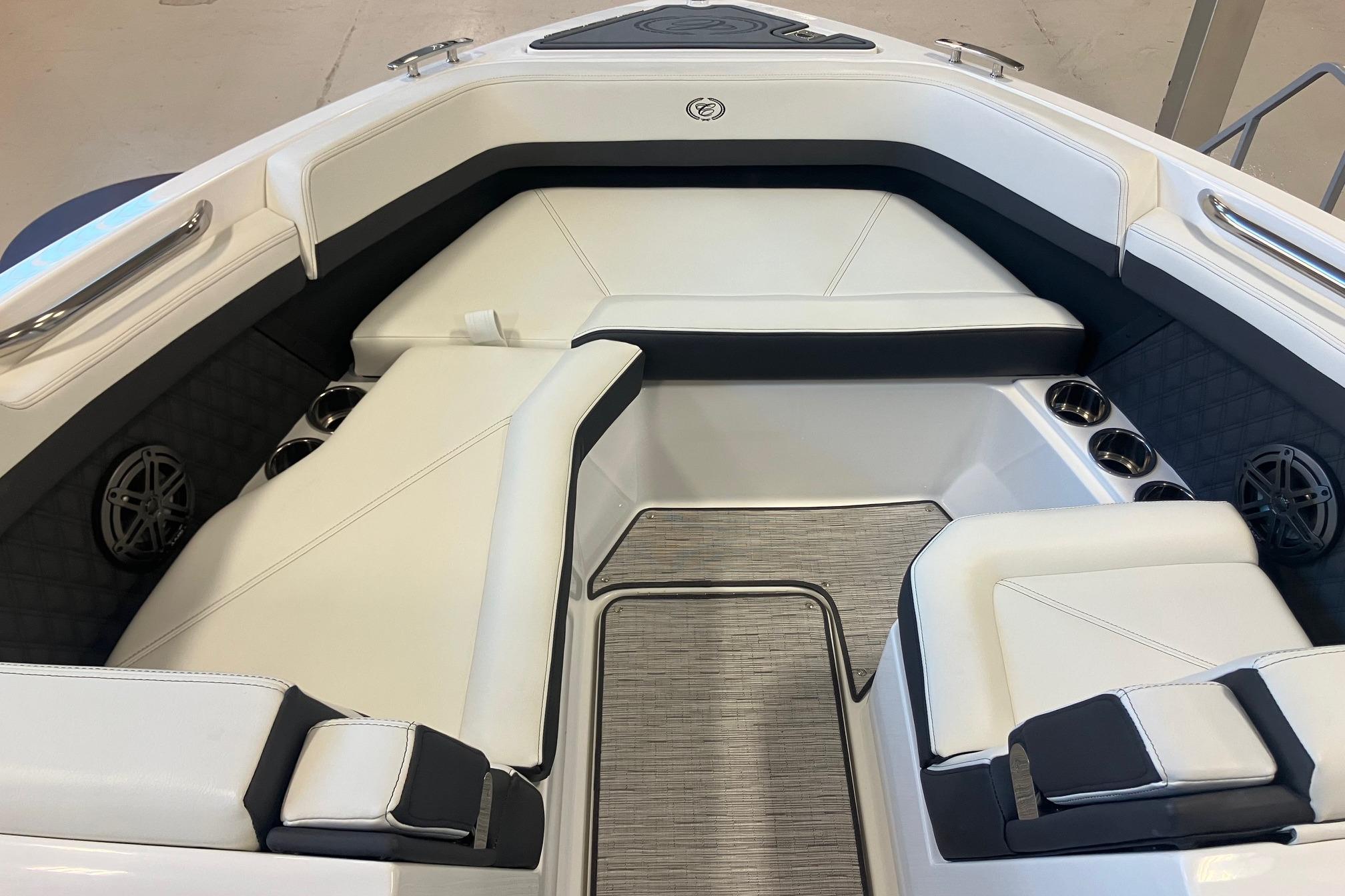2026 Cobalt R6 boat interior with white seating, cup holders, and speakers.