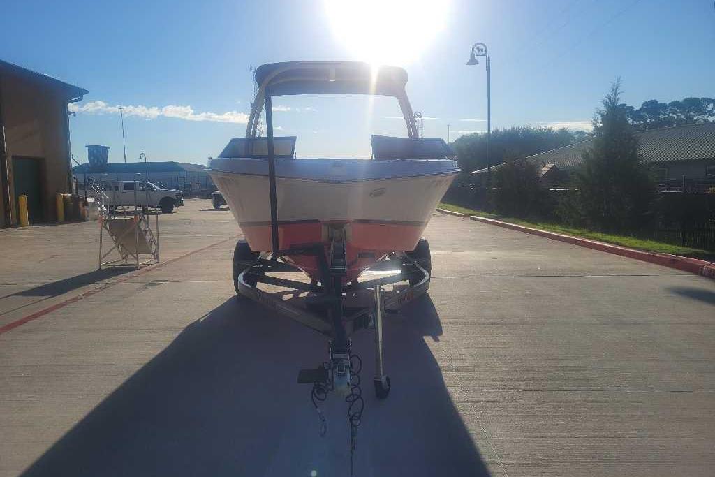 2016 Four Winns H200RS boat on trailer, parked outdoors under bright sunlight.