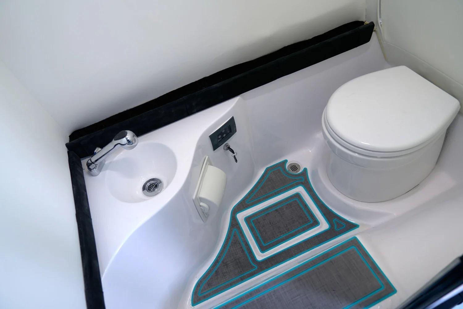 Manufacturer Provided Image: Compact bathroom in 2025 Statement 430 Tigress boat with toilet and sink.