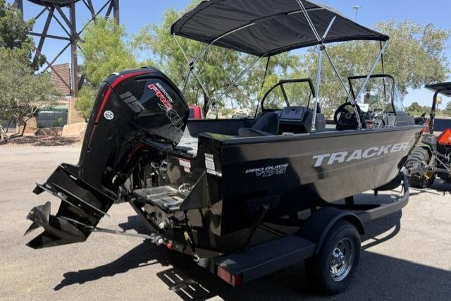 2026 Tracker Pro Guide V-175 WT boat with outboard motor and canopy, parked on a trailer.