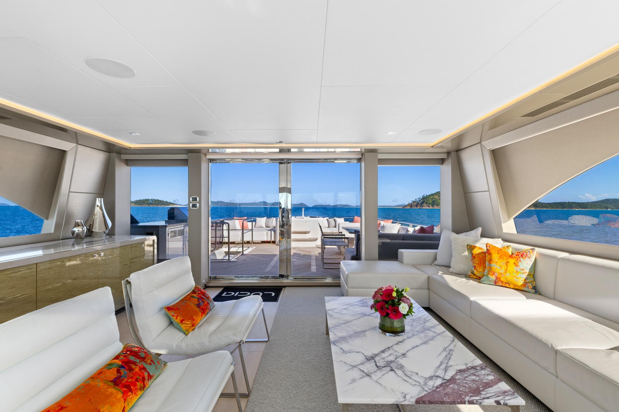 Luxurious interior of 2023 Ocean Alexander 28E yacht with elegant seating and ocean views.