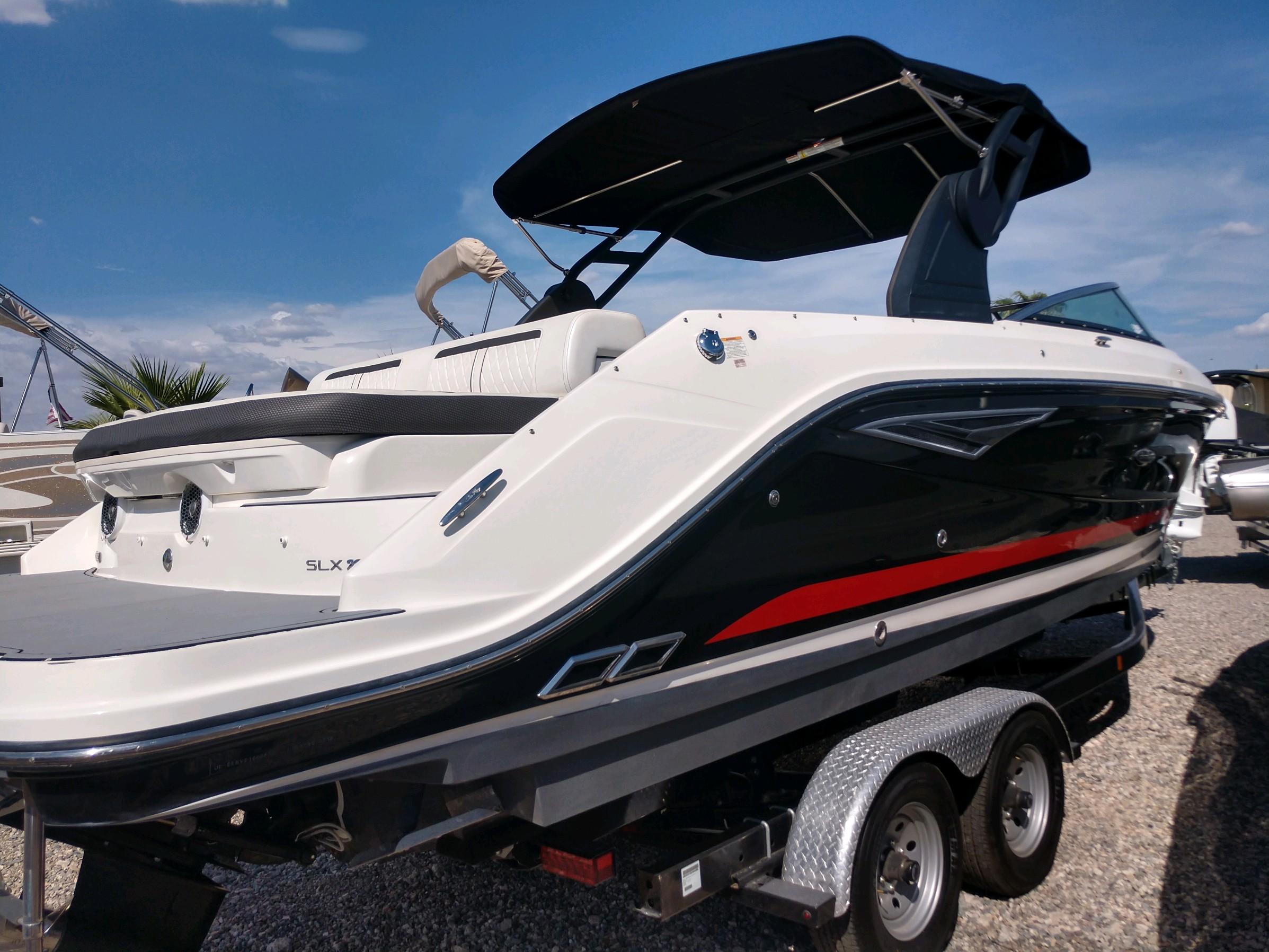 2018 Sea Ray SLX 280 boat on trailer under clear blue sky.