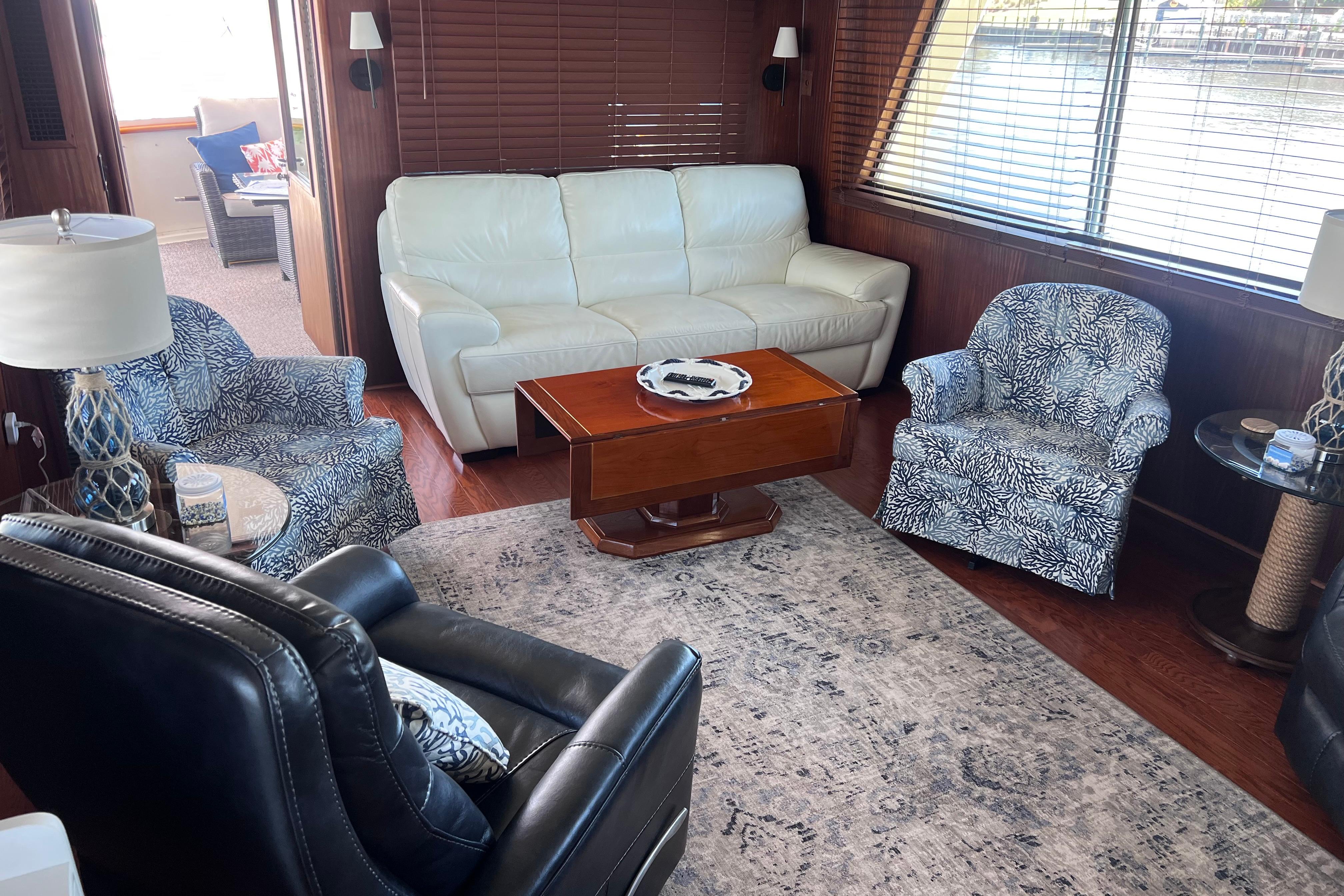 Luxurious interior of 1987 Hatteras 70 Cockpit Motor Yacht with elegant seating and decor.
