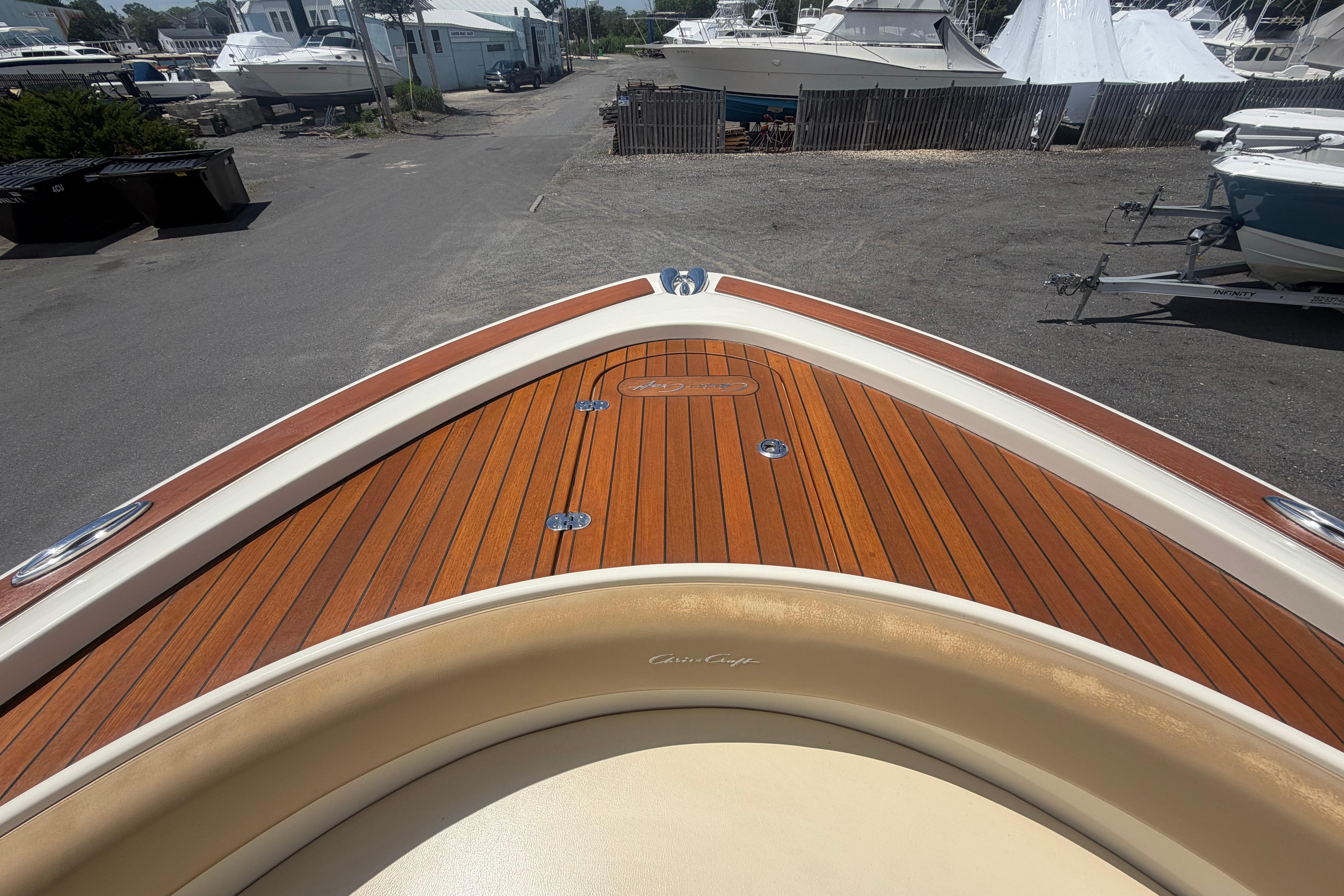 2017 Chris-Craft Catalina 34 boat with elegant wooden deck, docked in a marina.