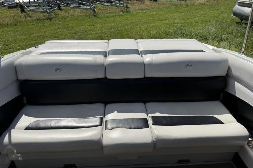 2012 Crownline 215 SS boat interior with cushioned seating, outdoors on grass.