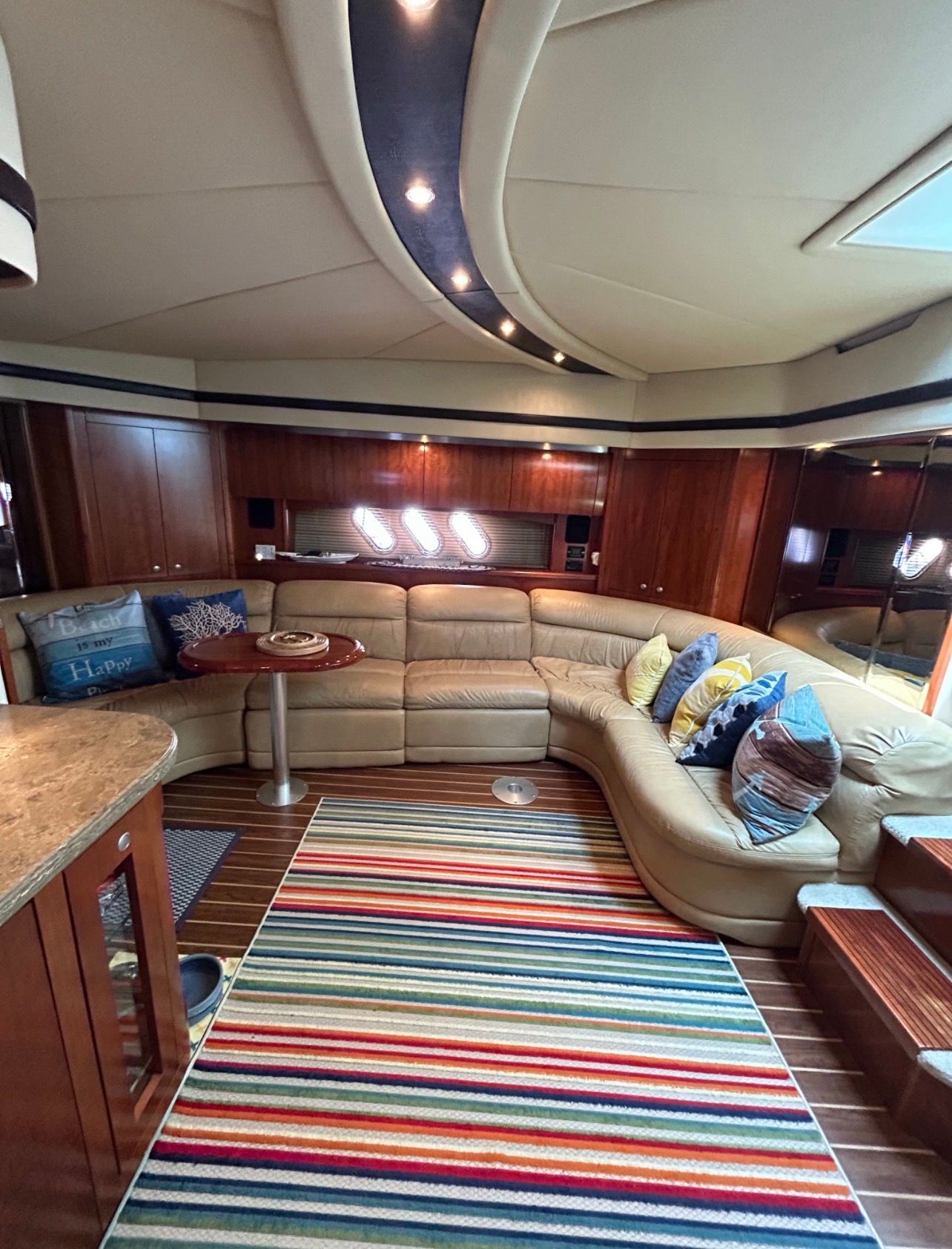 Interior of the 2009 Cruisers Yachts 520 Sports Coupe with elegant seating and striped carpet.
