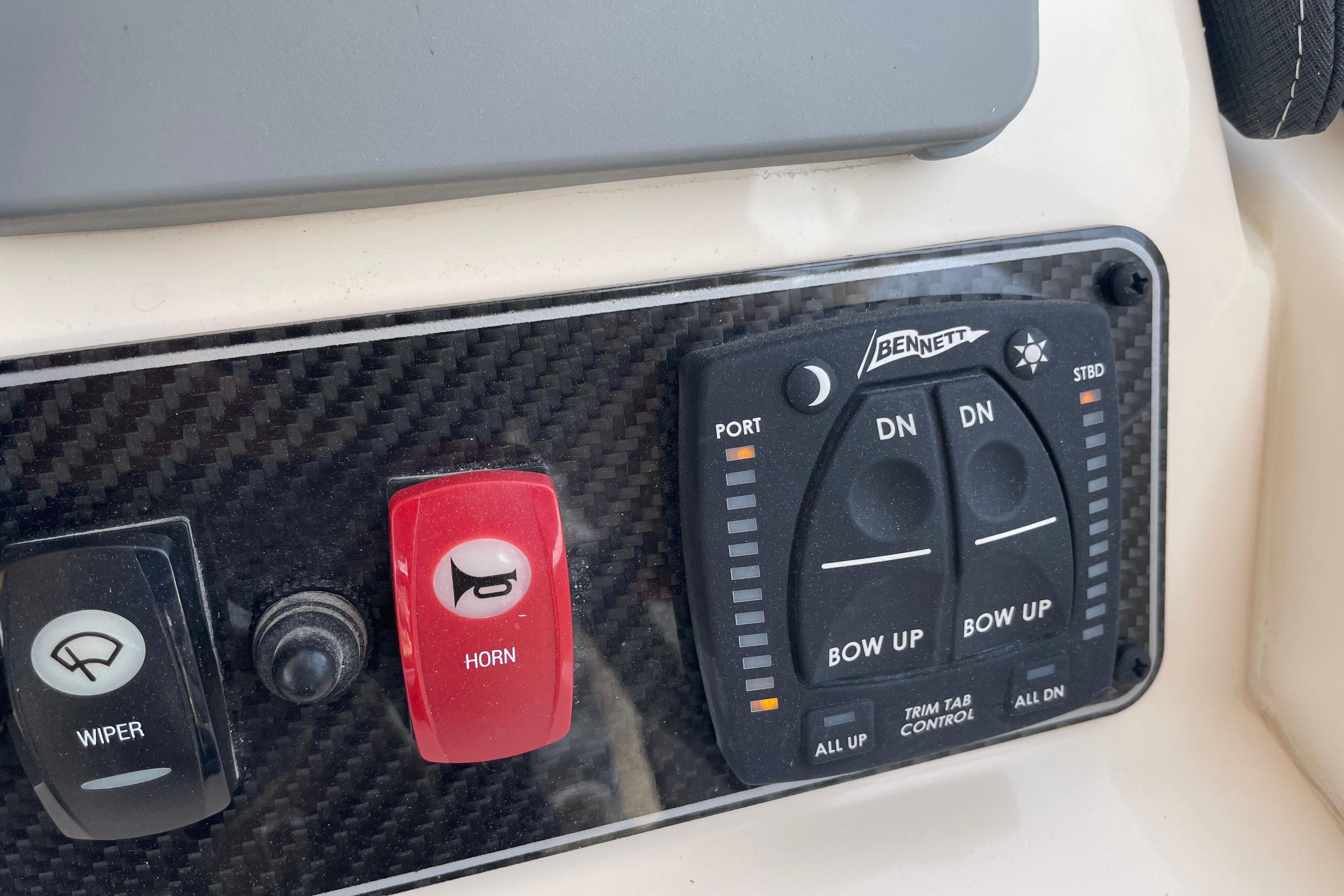 Control panel of 2024 Grady-White Adventure 218 boat with wiper and horn switches.