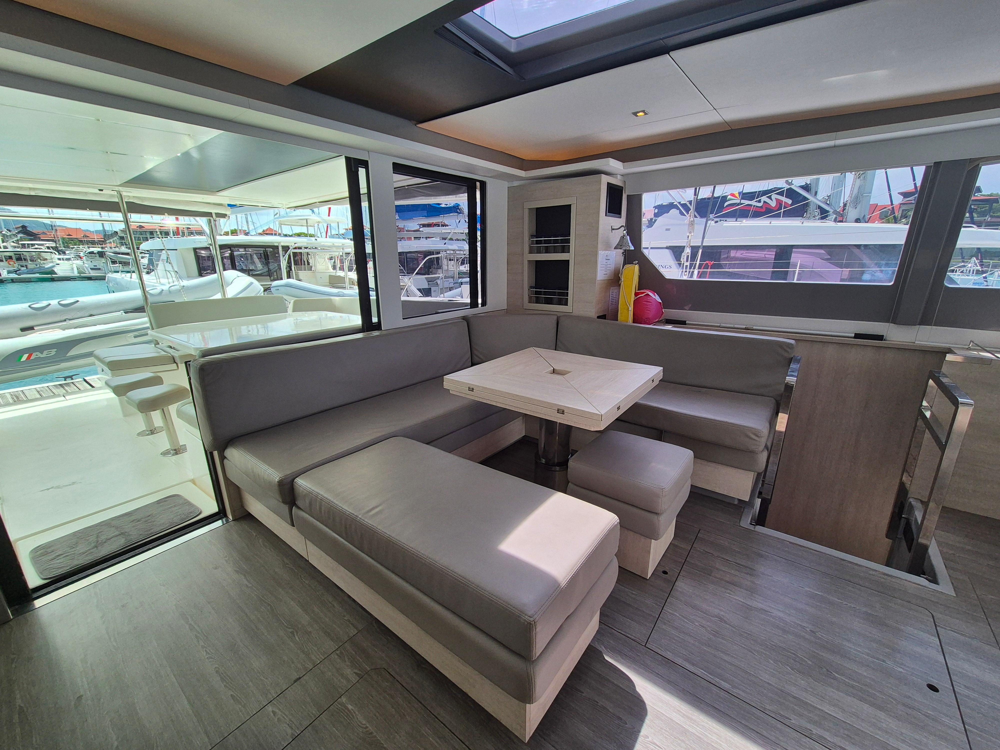 Luxurious interior of a 2020 Leopard 50 yacht with modern seating and dining area.