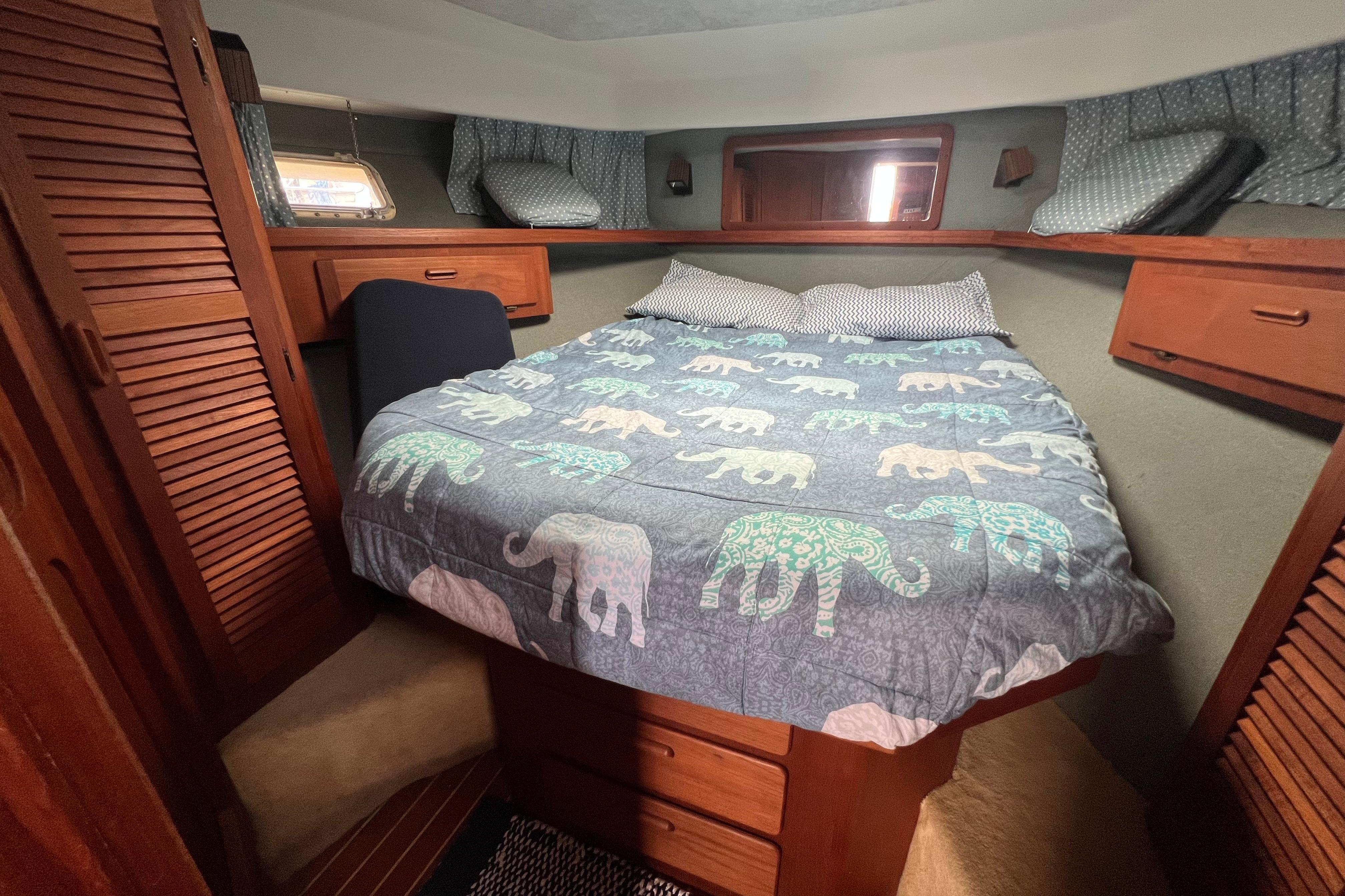 Cozy cabin interior of 1985 Tiara 36 OPEN with elephant-patterned bedding.