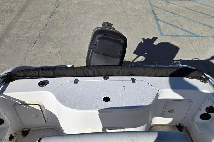 2001 Pro-Line 19 Sport boat interior with open storage compartment and motor.