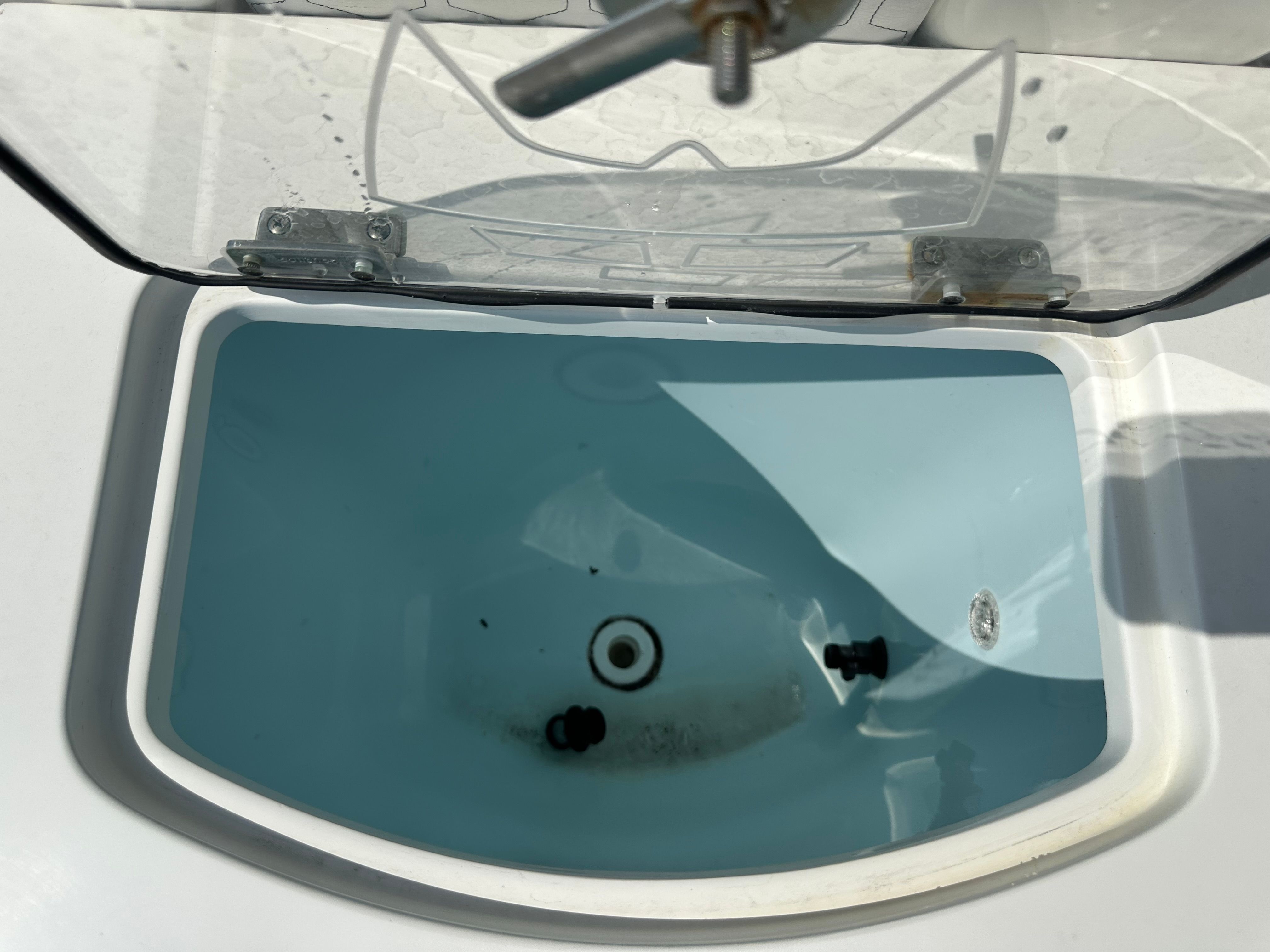 An open compartment with water, possibly a livewell on a boat.