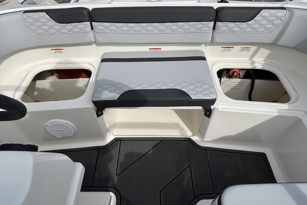 2025 Bayliner Element M17 boat interior with seating and storage compartments.