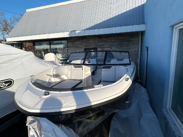 2024 Bayliner Element M19 boat parked outdoors near a building.