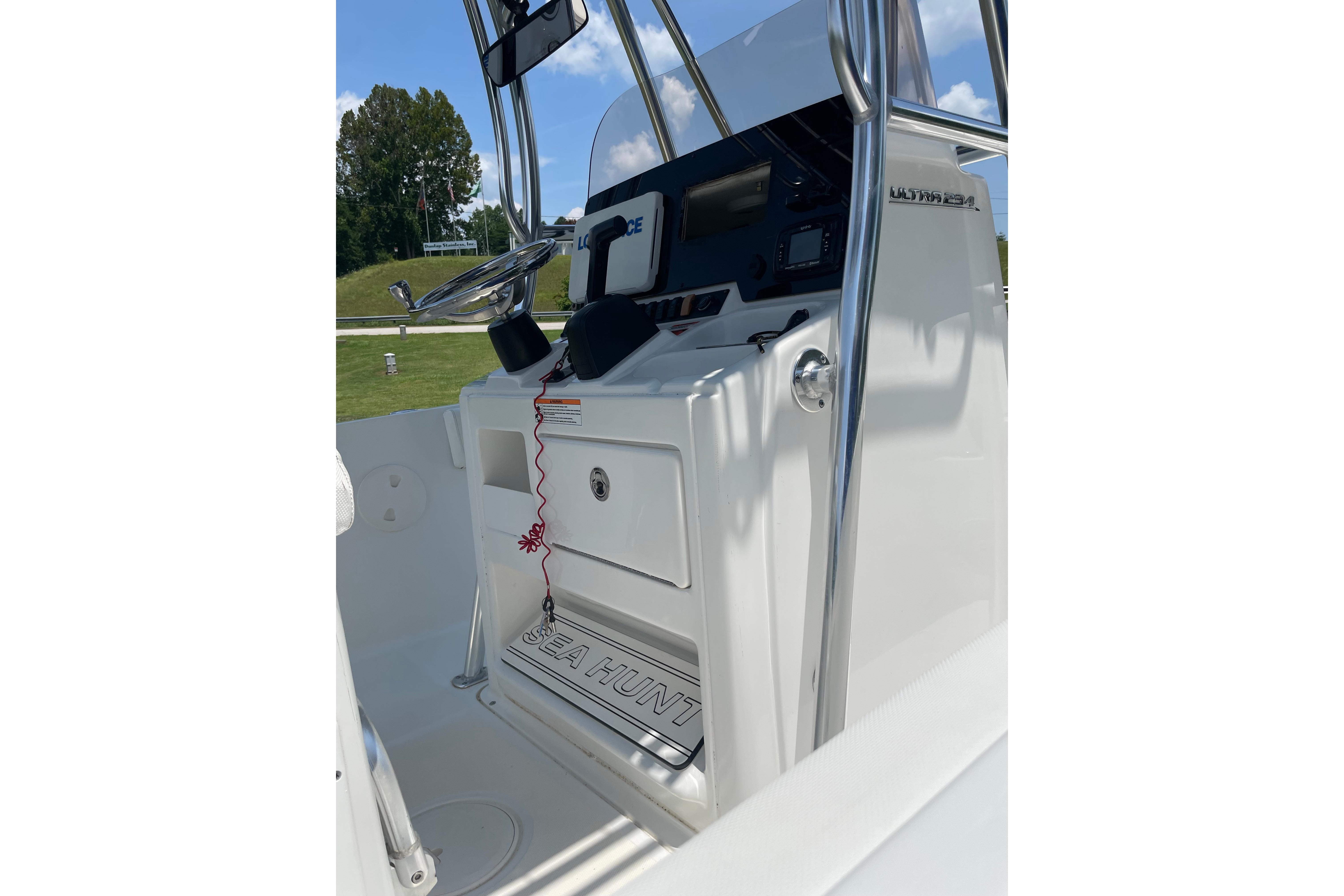 2018 Sea Hunt Ultra 234 boat console with steering wheel and navigation equipment.