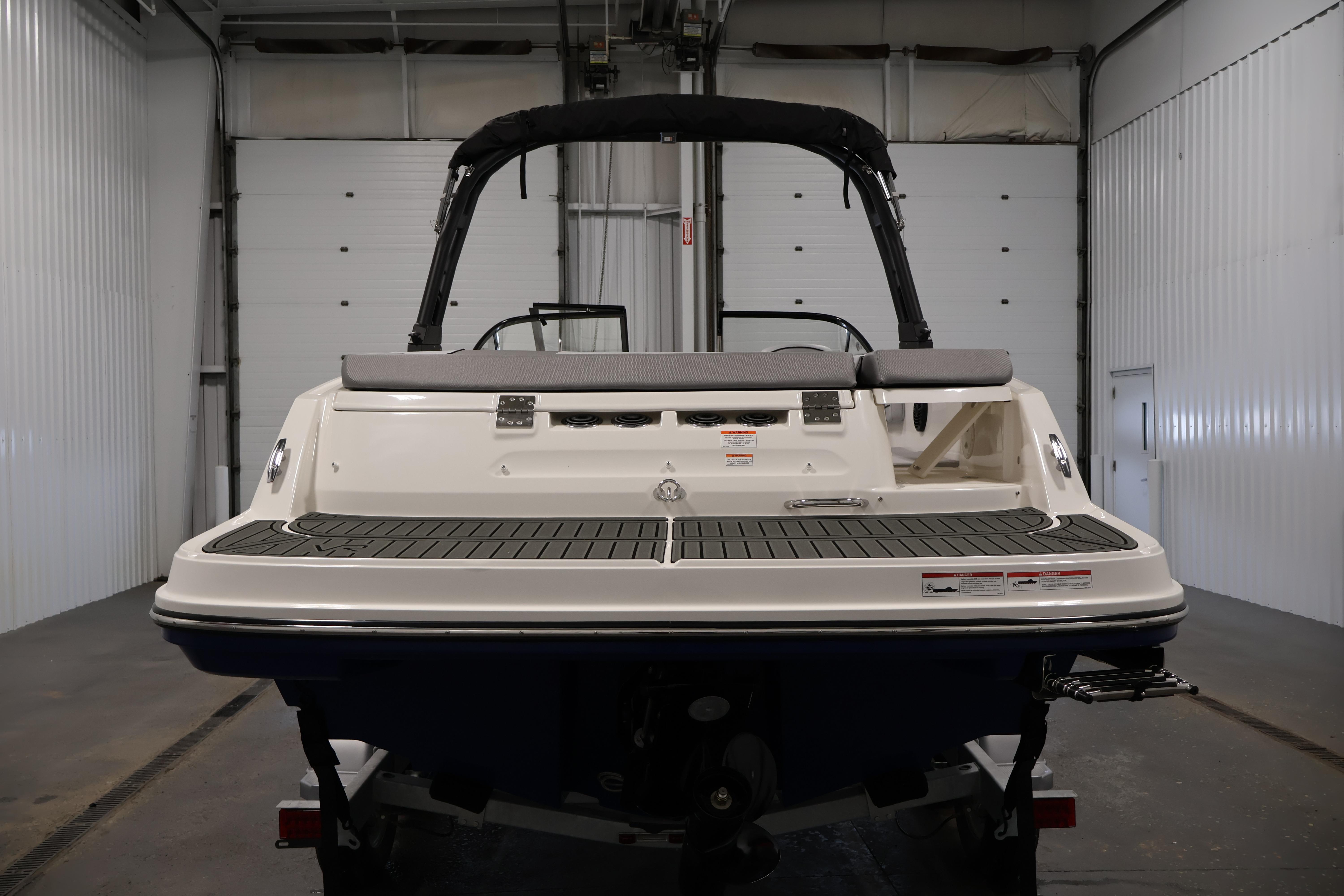 2026 Bayliner VR6 Bowrider I/O in a garage, rear view.