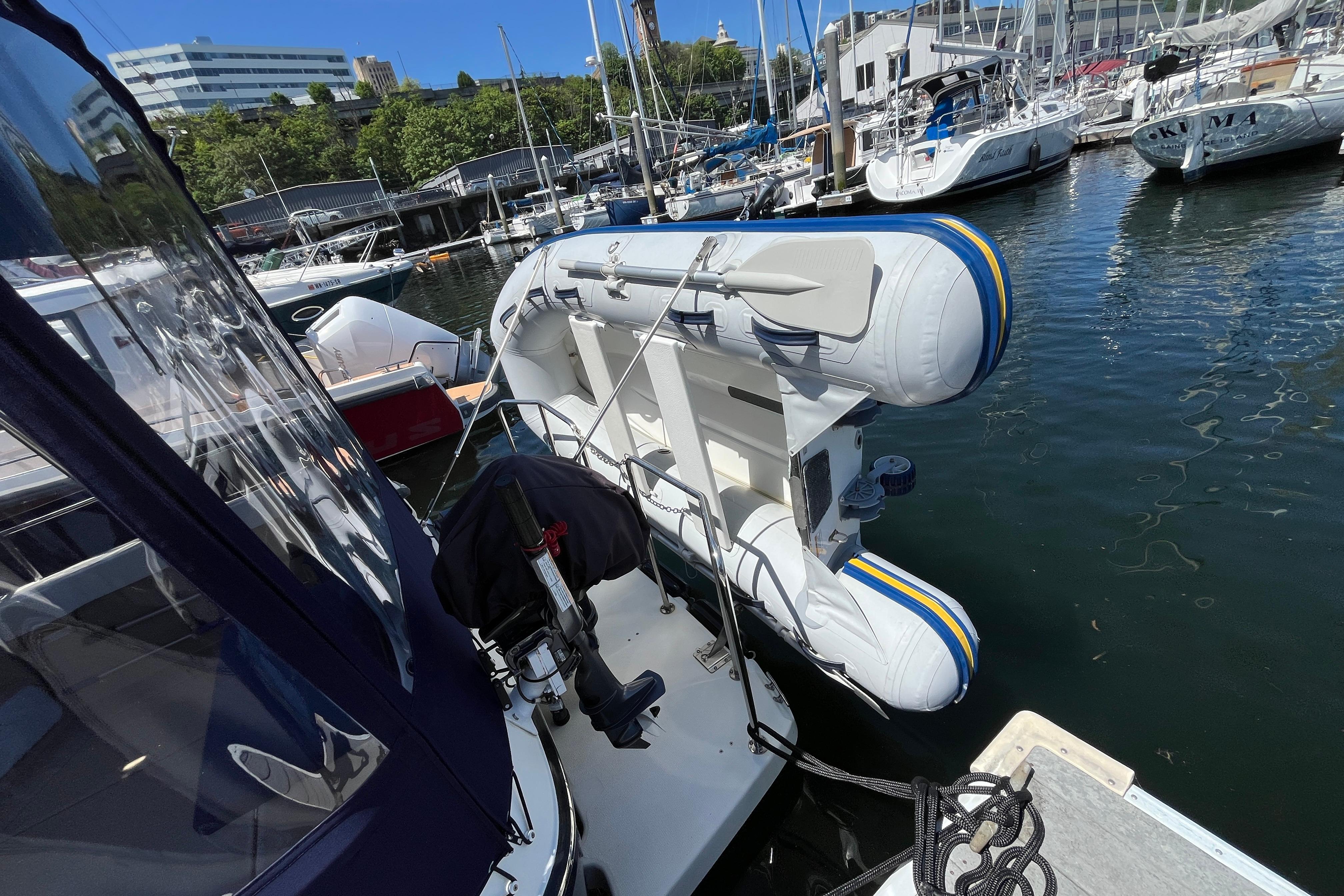 2017 Ranger Tugs R-27 with inflatable dinghy docked at a marina.
