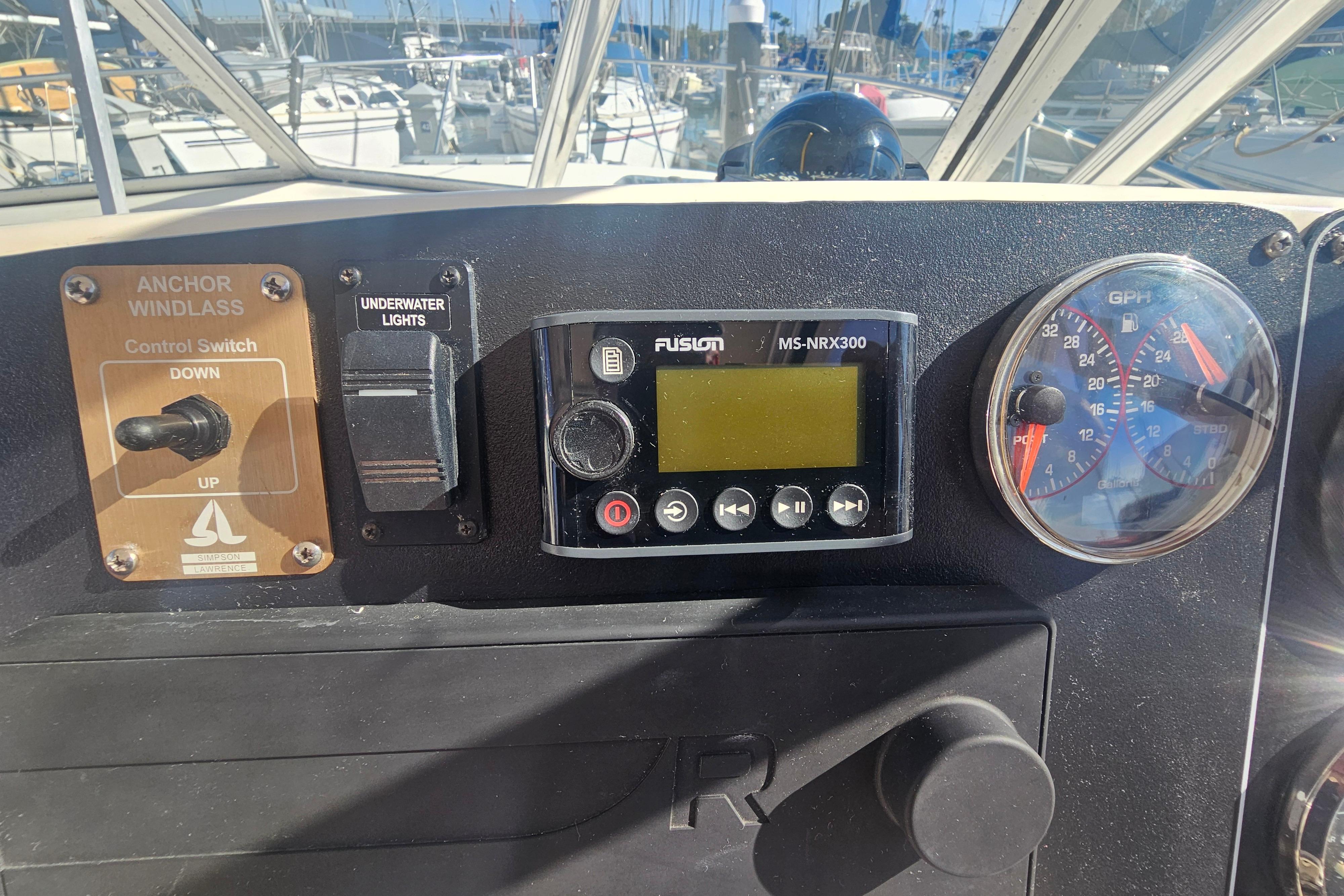 Control panel of a 2001 Pursuit 3000 Express boat with gauges and switches.